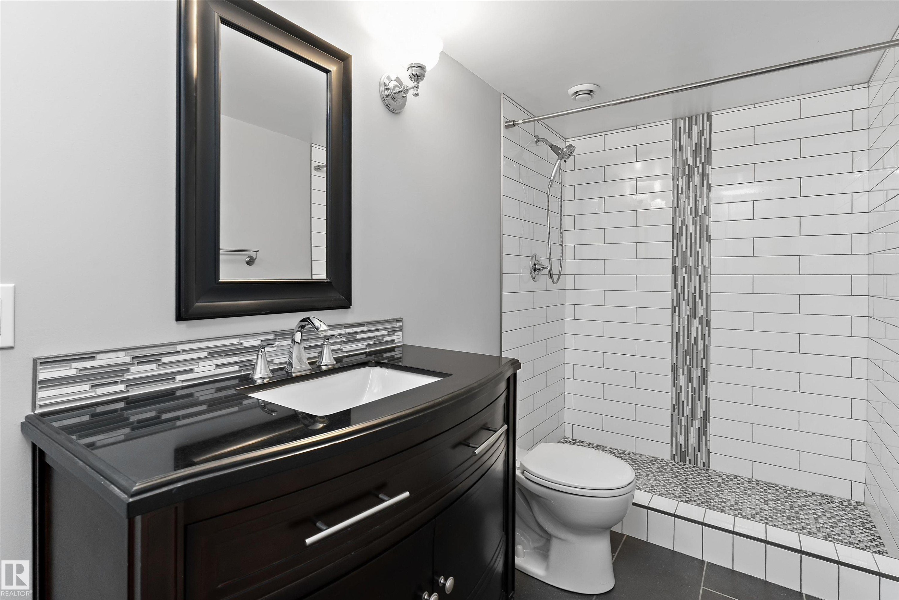 Dark wood-finish vanity with an undermount sink - 20845 92A Avenue Nw, Edmonton, AB - Indoor Photo Showing Bathroom