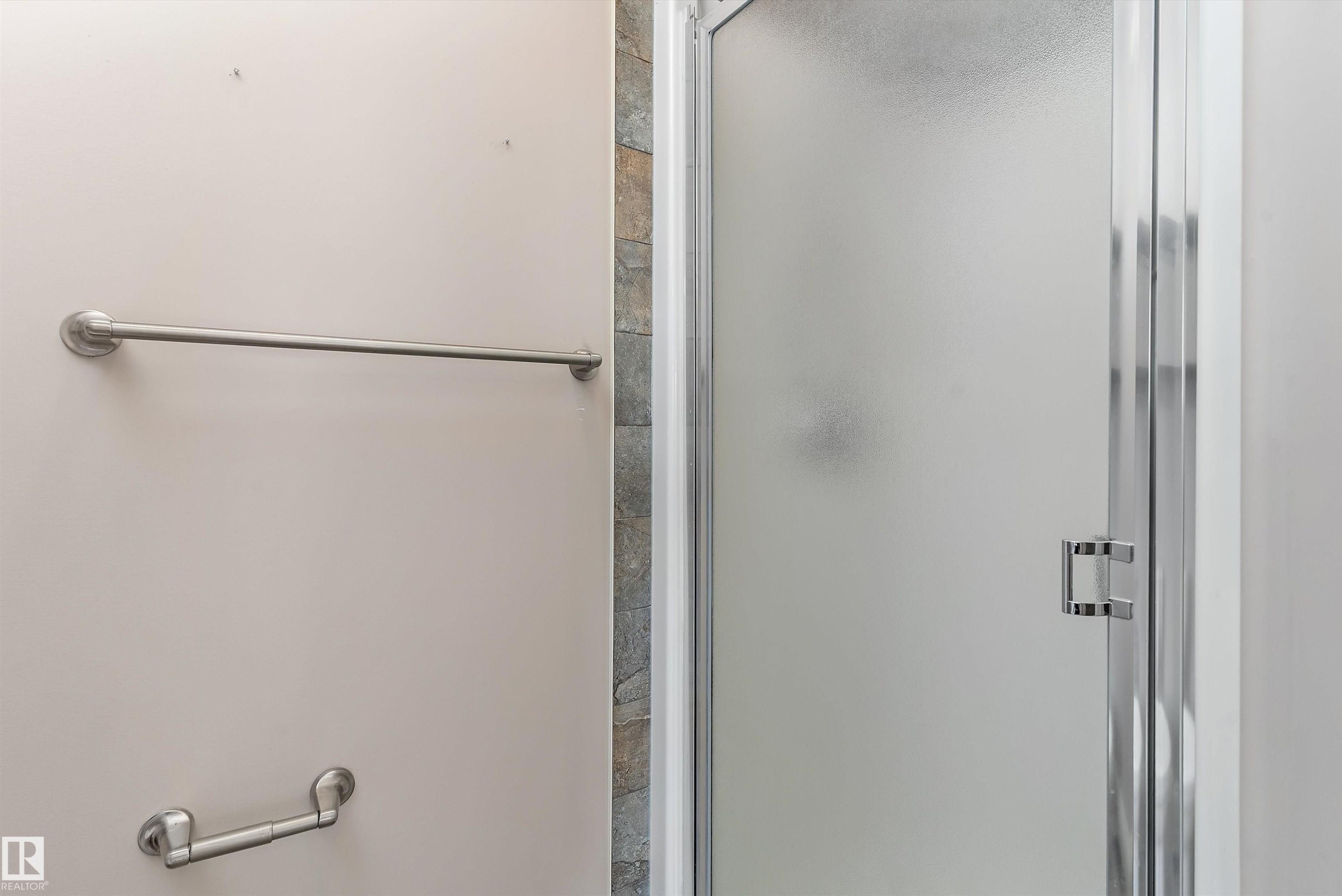 Enclosed shower with a frosted glass door and a chrome handle - 20845 92A Avenue Nw, Edmonton, AB - Indoor Photo Showing Bathroom