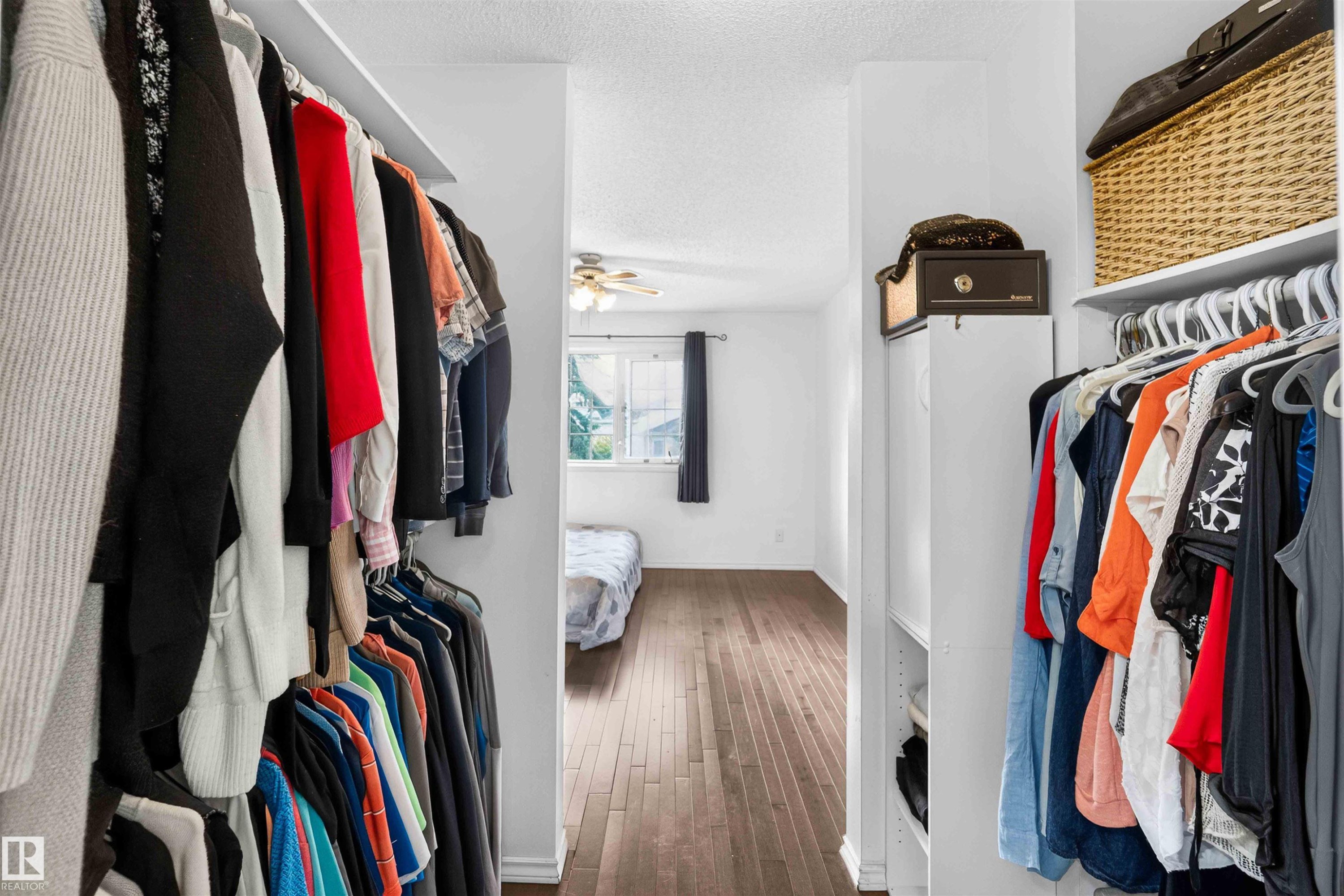 Walk-in closet with built-in shelving and hanging rods - #28 3645 145 Av Nw, Edmonton, AB - Indoor With Storage