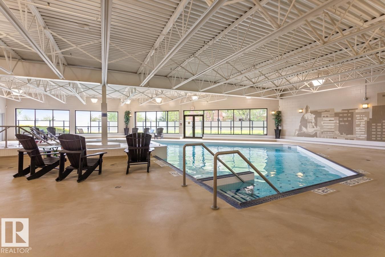 Indoor swimming pool with integrated steps and handrail - #210 7909 71 St Nw, Edmonton, AB - Indoor Photo Showing Other Room With In Ground Pool