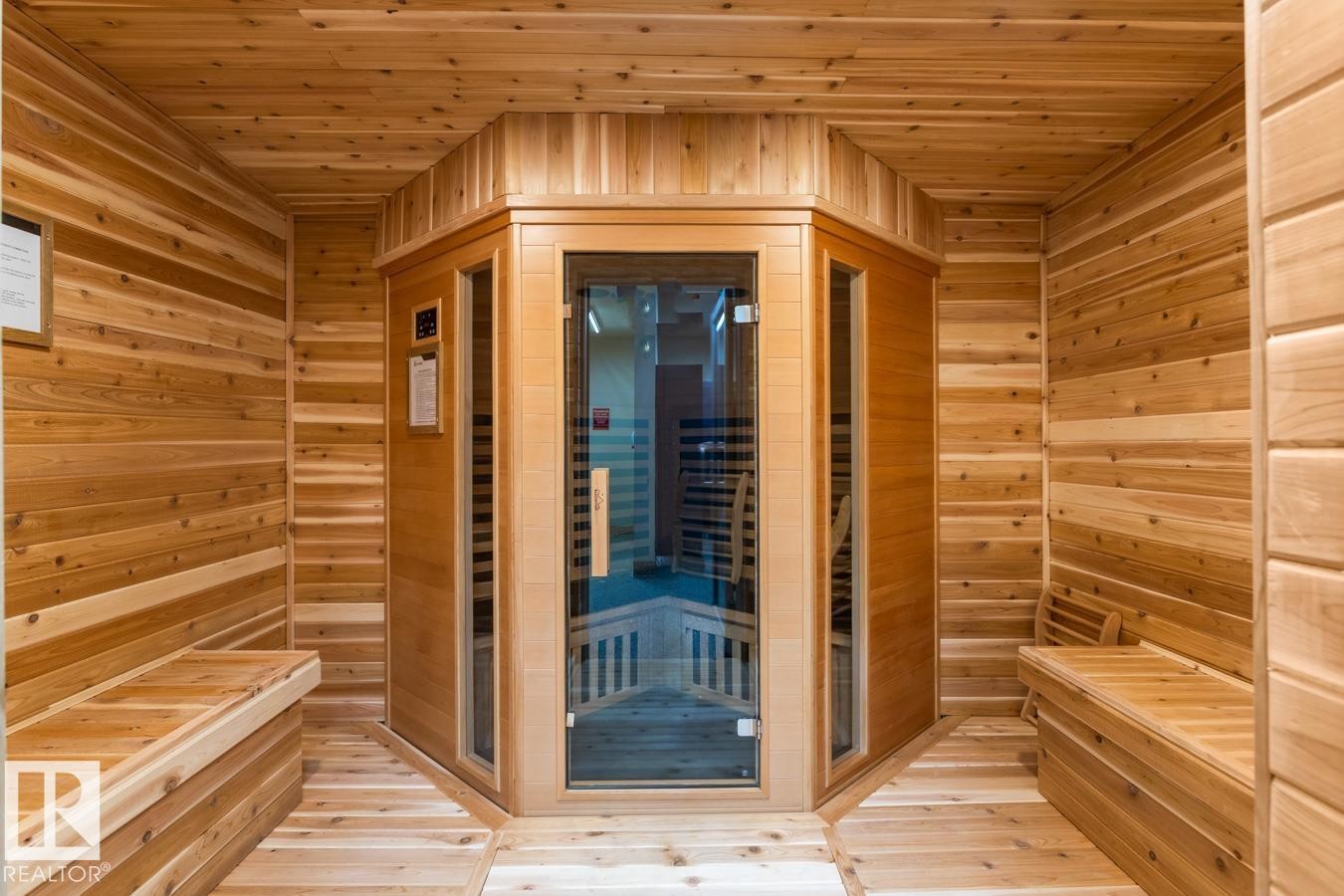 Cedar-lined sauna room featuring built-in wooden benches, natural wood plank walls, and a glass-paneled sauna unit - #210 7909 71 St Nw, Edmonton, AB - Indoor Photo Showing Other Room