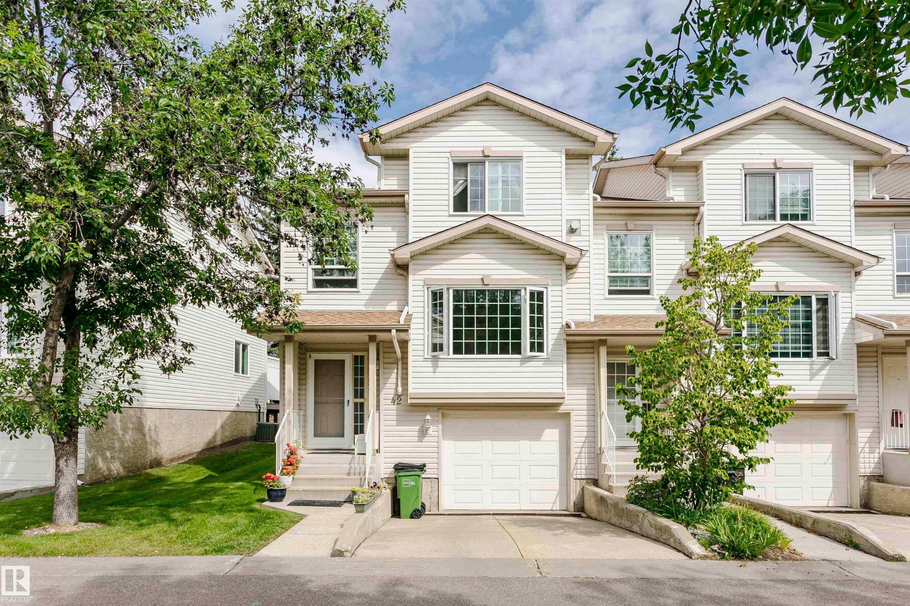 Multi-story residence featuring light-colored siding and a gabled roofline - #42 9630 176 St Nw, Edmonton, AB - Outdoor With Facade