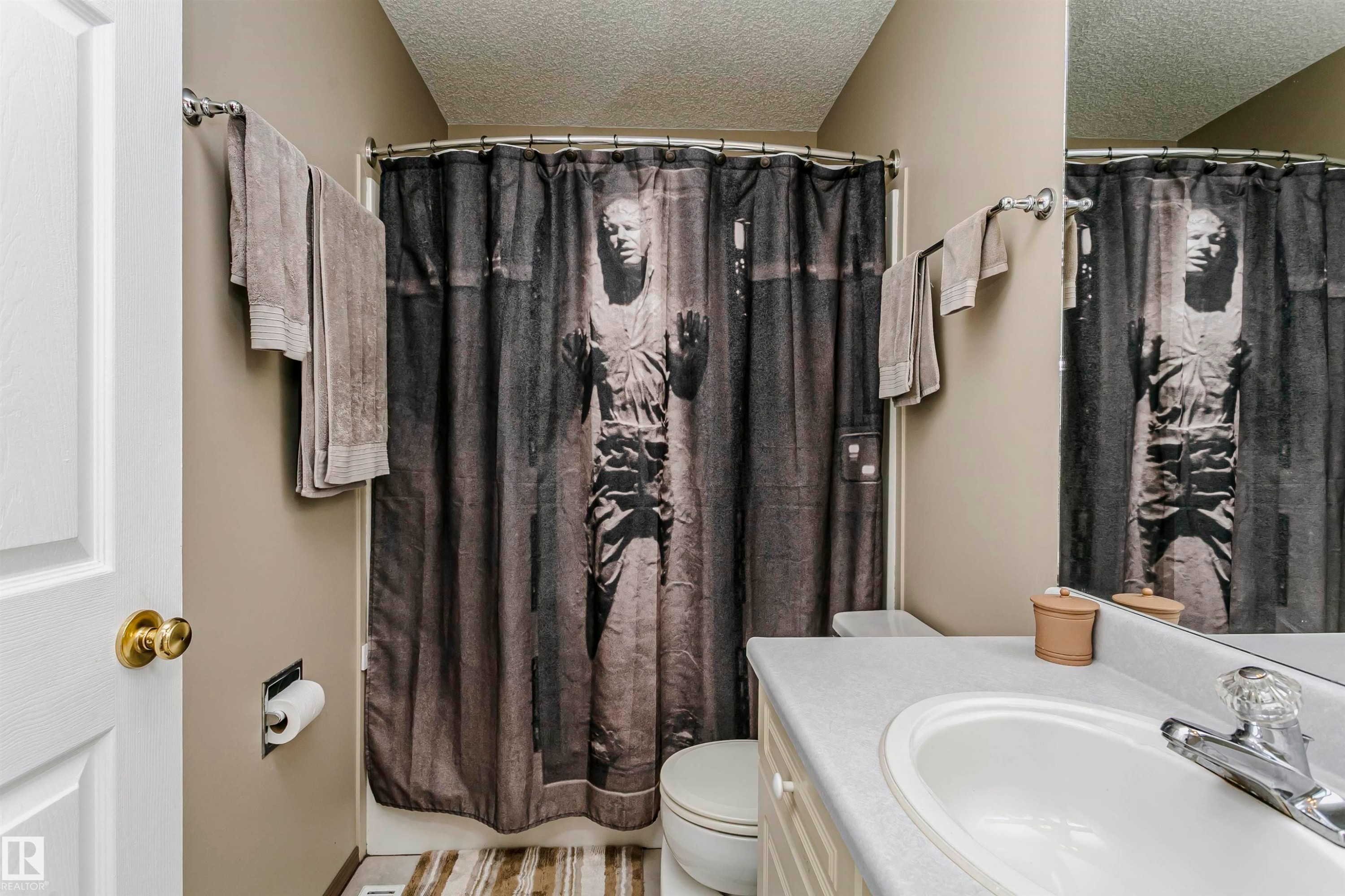 White vanity with integrated sink, chrome faucet, and a large wall-mounted mirror - #42 9630 176 St Nw, Edmonton, AB - Indoor Photo Showing Bathroom