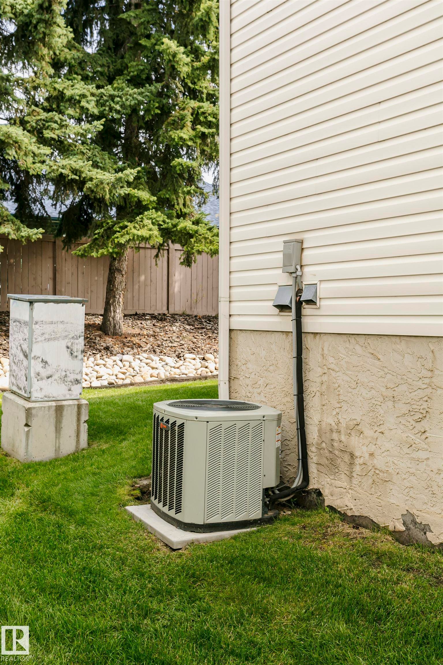 Exterior featuring horizontal siding, a visible air conditioning unit, and a concrete foundation - #42 9630 176 St Nw, Edmonton, AB - Outdoor