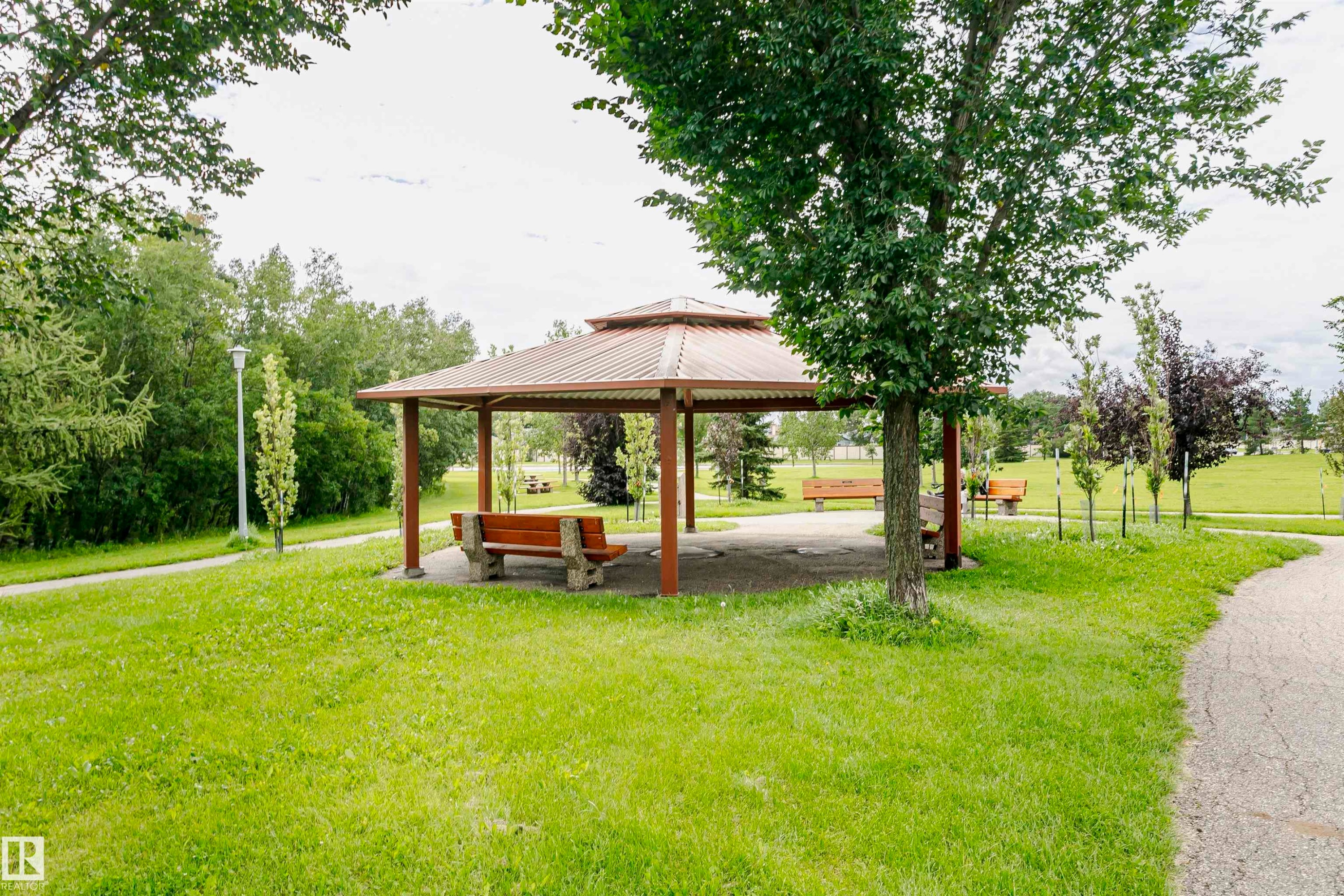 Gazebo with a multi-tiered roof, supported by sturdy posts, featuring a concrete base - #42 9630 176 St Nw, Edmonton, AB - Outdoor With Backyard
