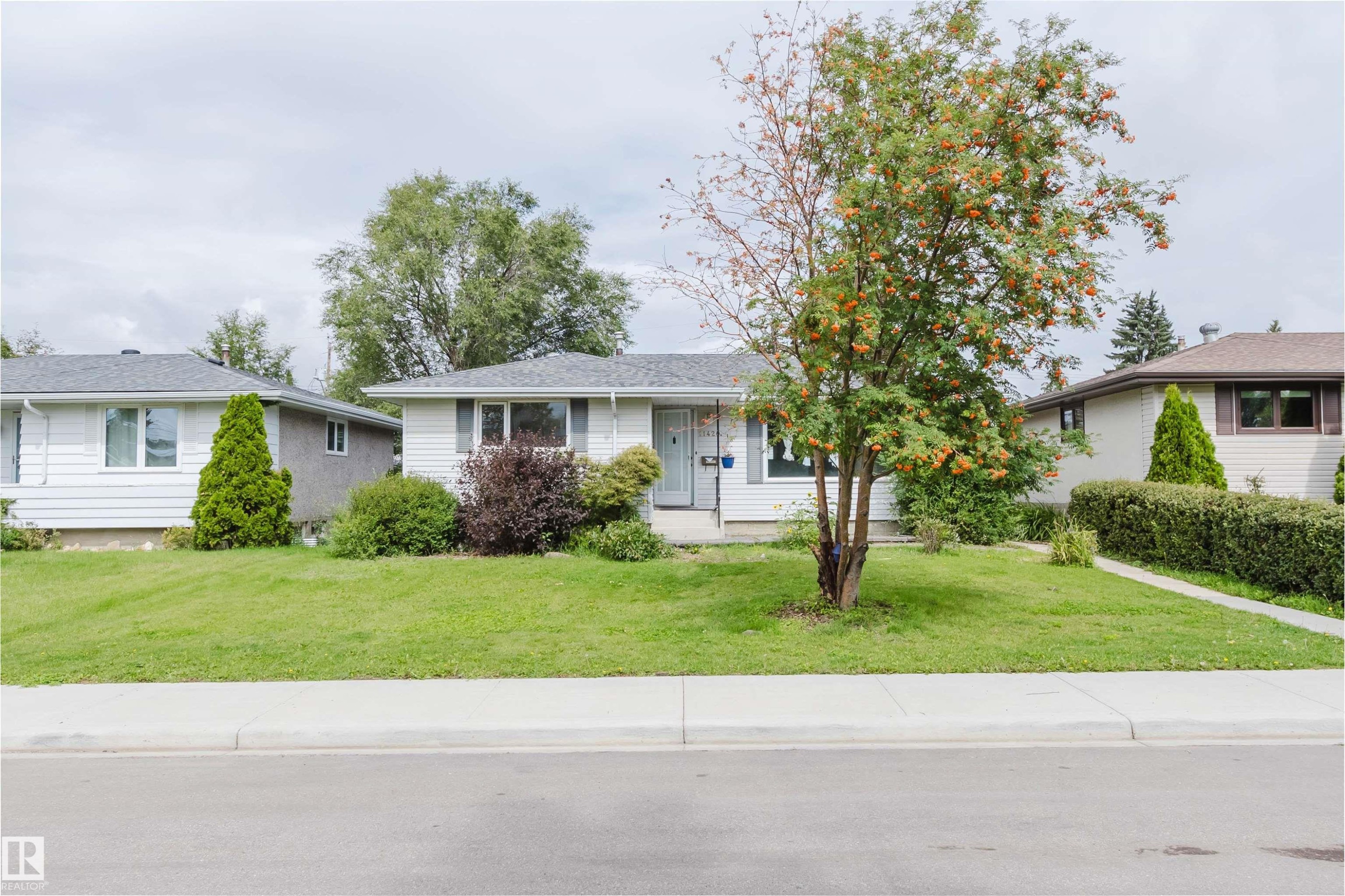 Charming ranch home situated on a mature landscaped lot featuring a sprawling lawn, established trees, and manicured foundation plantings - 11420 46 Avenue Nw, Edmonton, AB - Outdoor With Facade