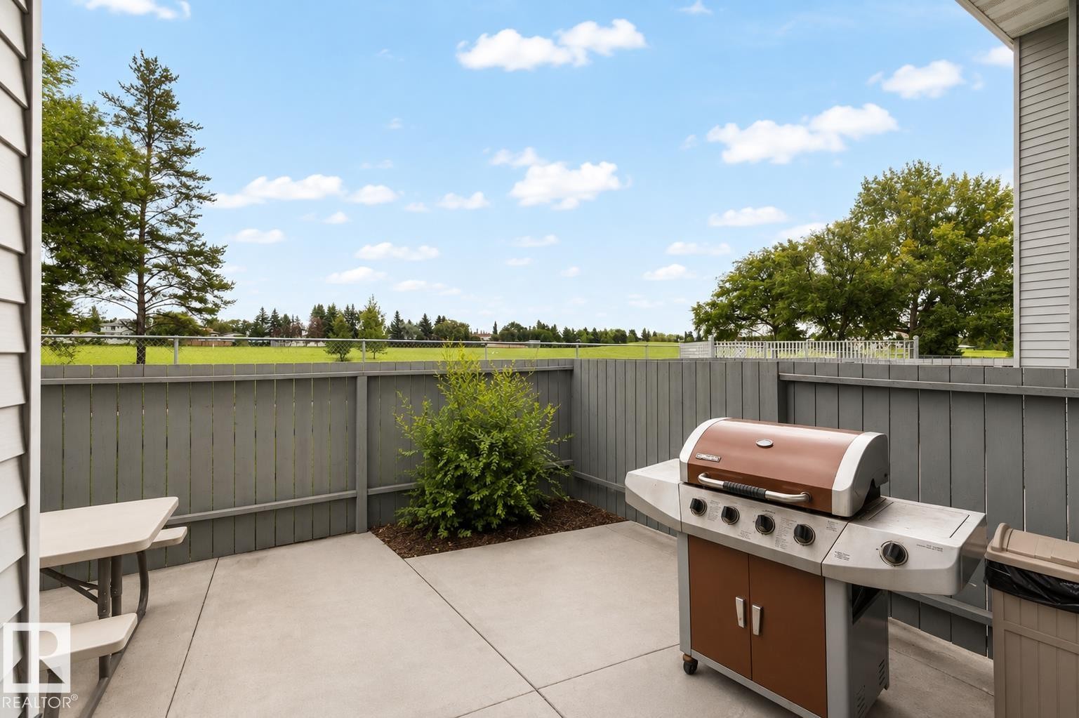 Private concrete patio with a wooden privacy fence - #44 1415 62 St Nw, Edmonton, AB - Outdoor With Deck Patio Veranda