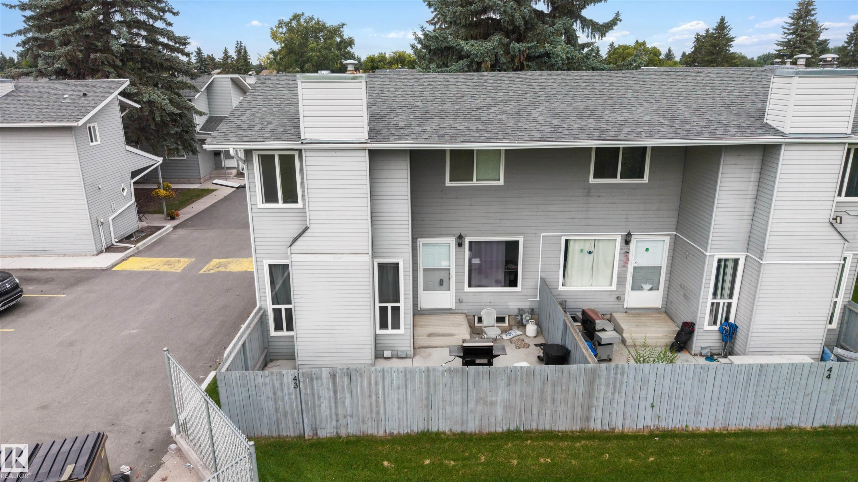 Rear patios with private fenced yards - #44 1415 62 St Nw, Edmonton, AB - Outdoor With Exterior