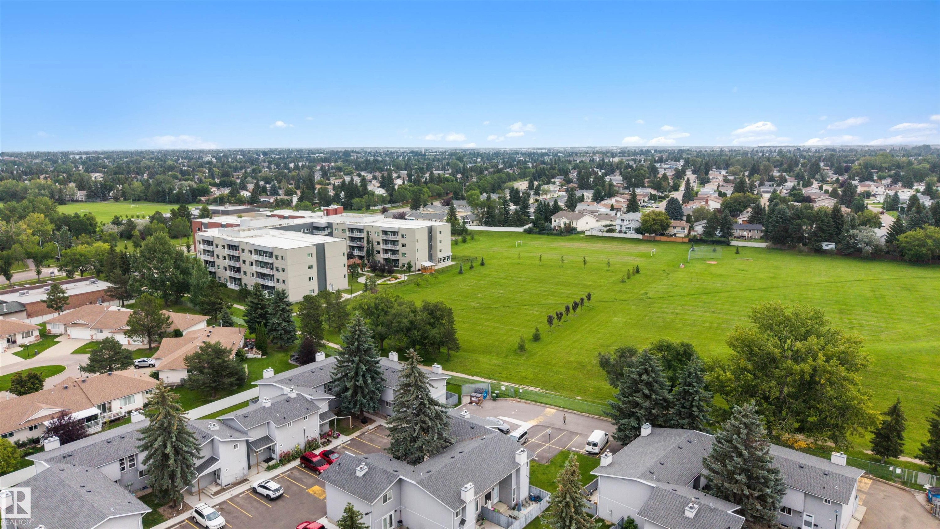 Expansive green spaces and mature trees surround the property - #44 1415 62 St Nw, Edmonton, AB - Outdoor With View
