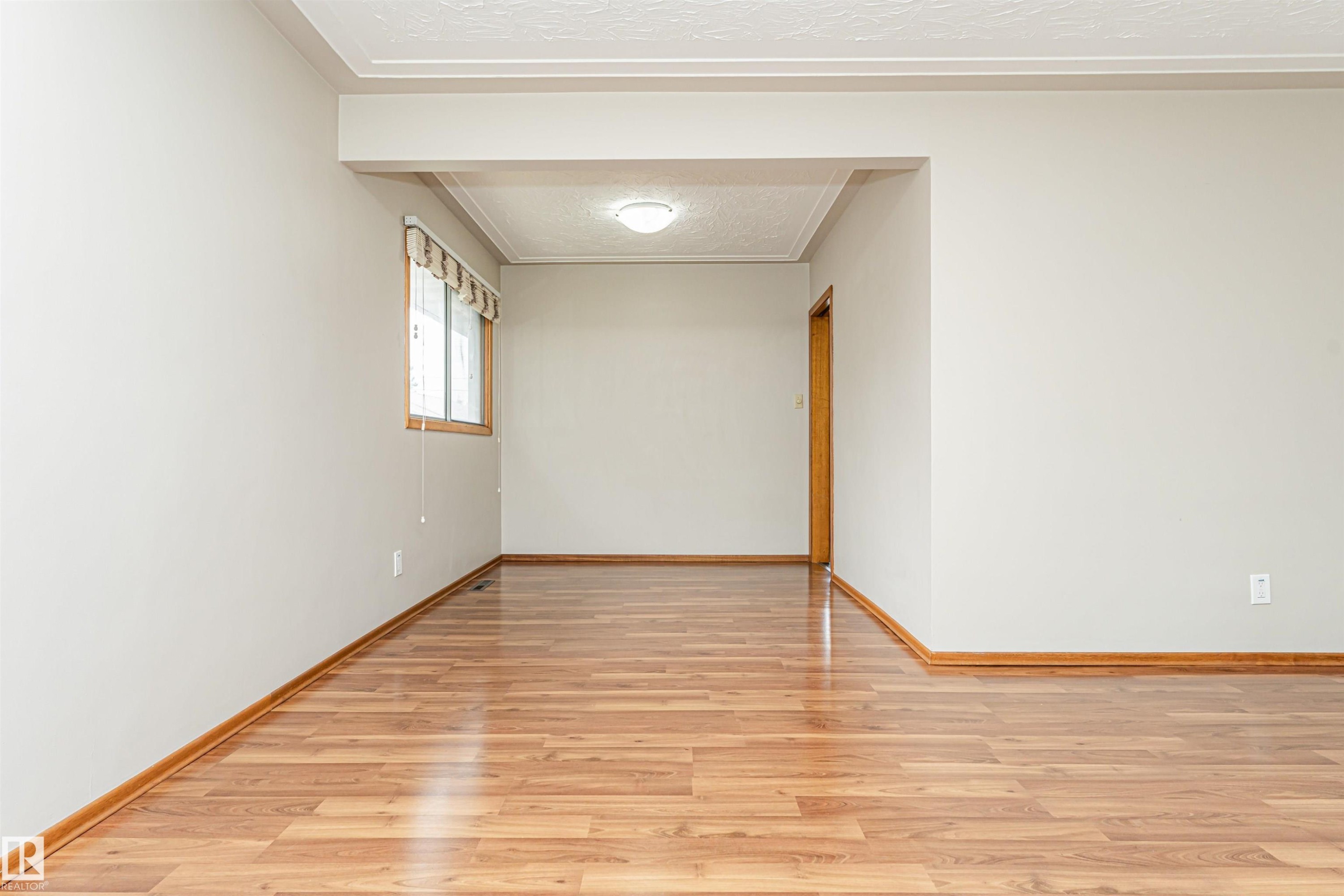 Recessed ceiling light fixture, wood-finish flooring, and a single window with wood framing - 11139 62 Avenue Nw, Edmonton, AB - Indoor Photo Showing Other Room