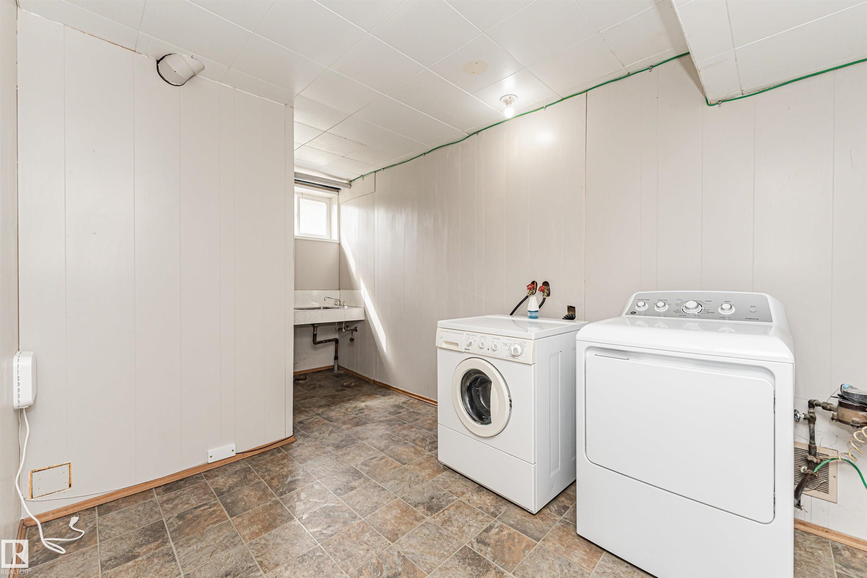 Utility space featuring a window, tile flooring, and white paneled walls - 11139 62 Avenue Nw, Edmonton, AB - Indoor Photo Showing Laundry Room