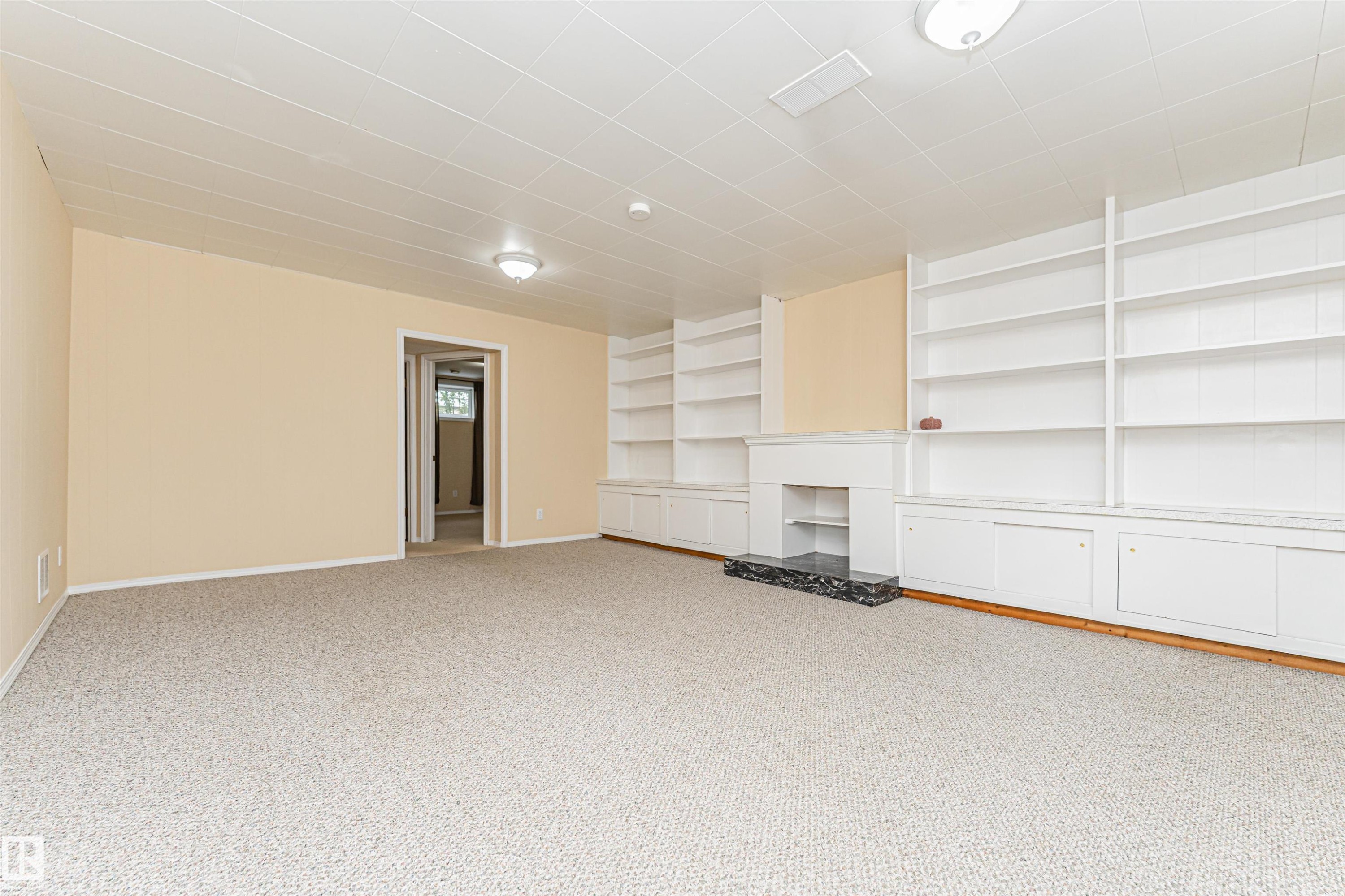 Expansive room featuring wall-to-wall carpeting and built-in shelving - 11139 62 Avenue Nw, Edmonton, AB - Indoor Photo Showing Other Room