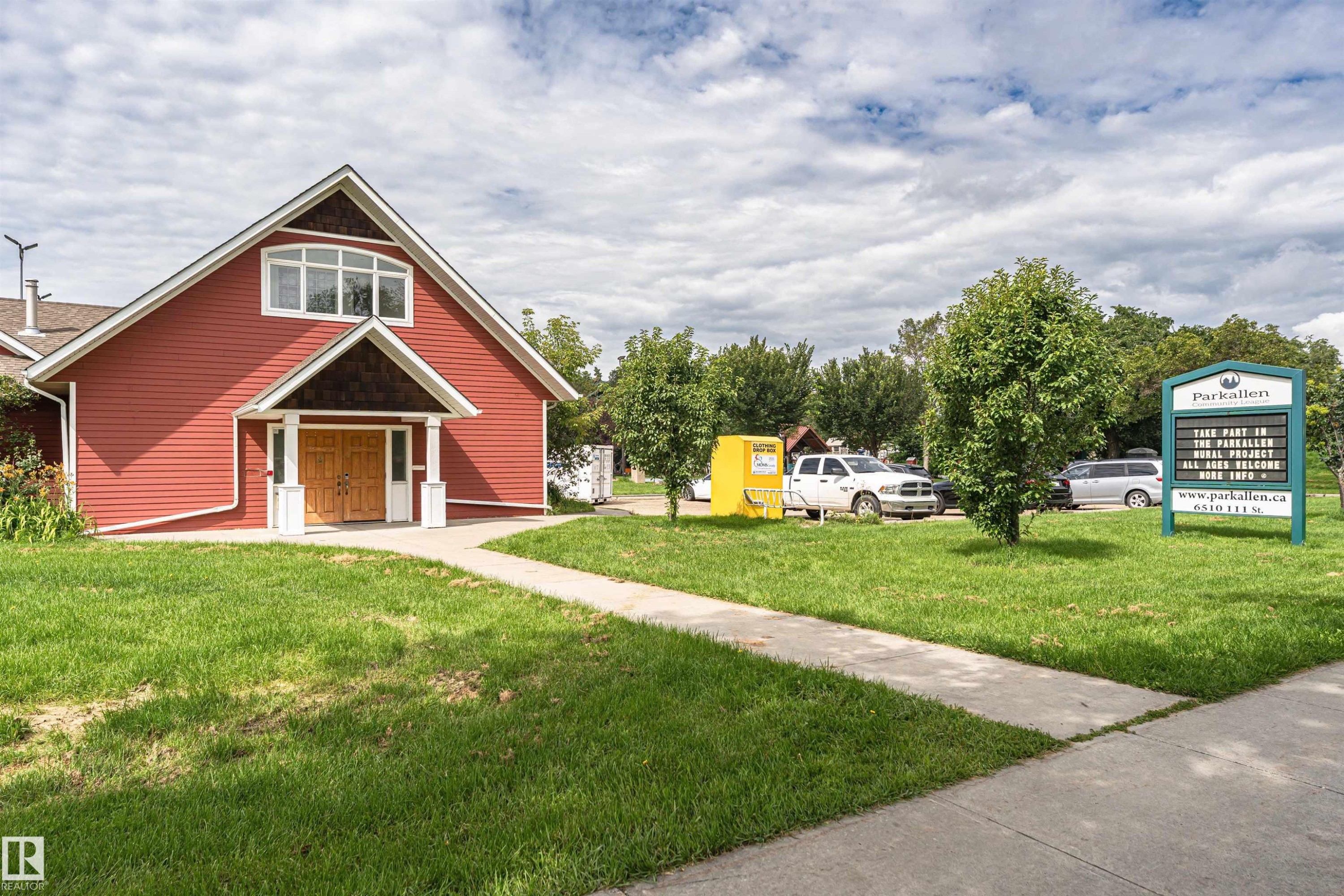 Gabled building with red siding, prominent window dormer, and wood double entry doors - 11139 62 Avenue Nw, Edmonton, AB - Outdoor
