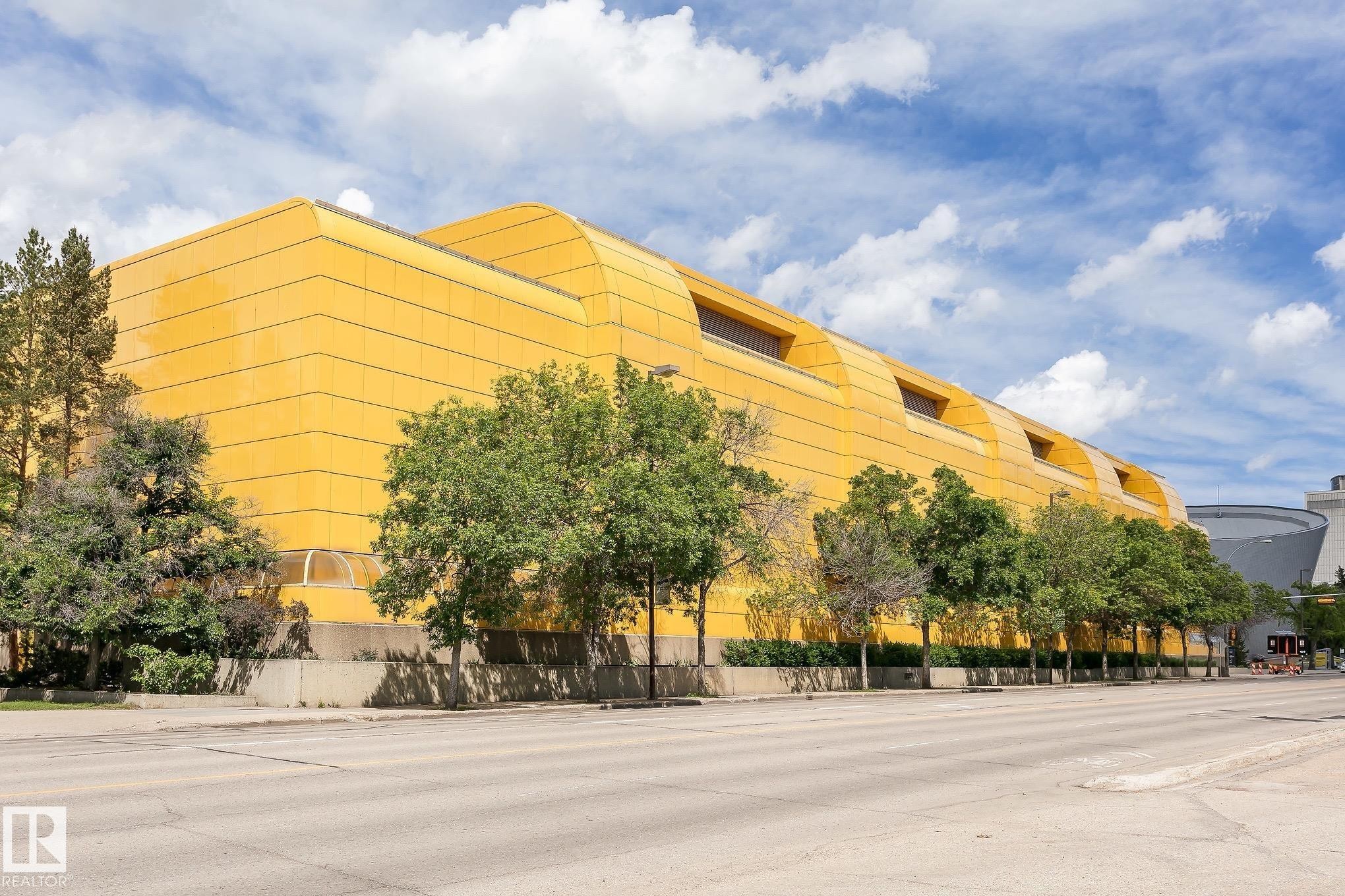 Architectural building with a distinctive yellow facade, prominent curved roofline, and multiple skylights - 11139 62 Avenue Nw, Edmonton, AB - Outdoor