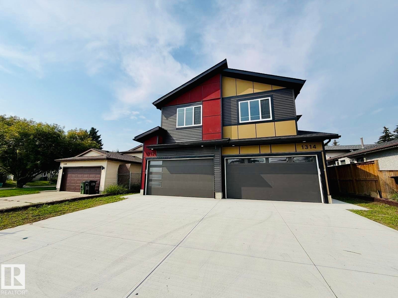 Modern duplex exterior with multi-color siding and a dark roofline - 1312 35 Street Nw, Edmonton, AB
