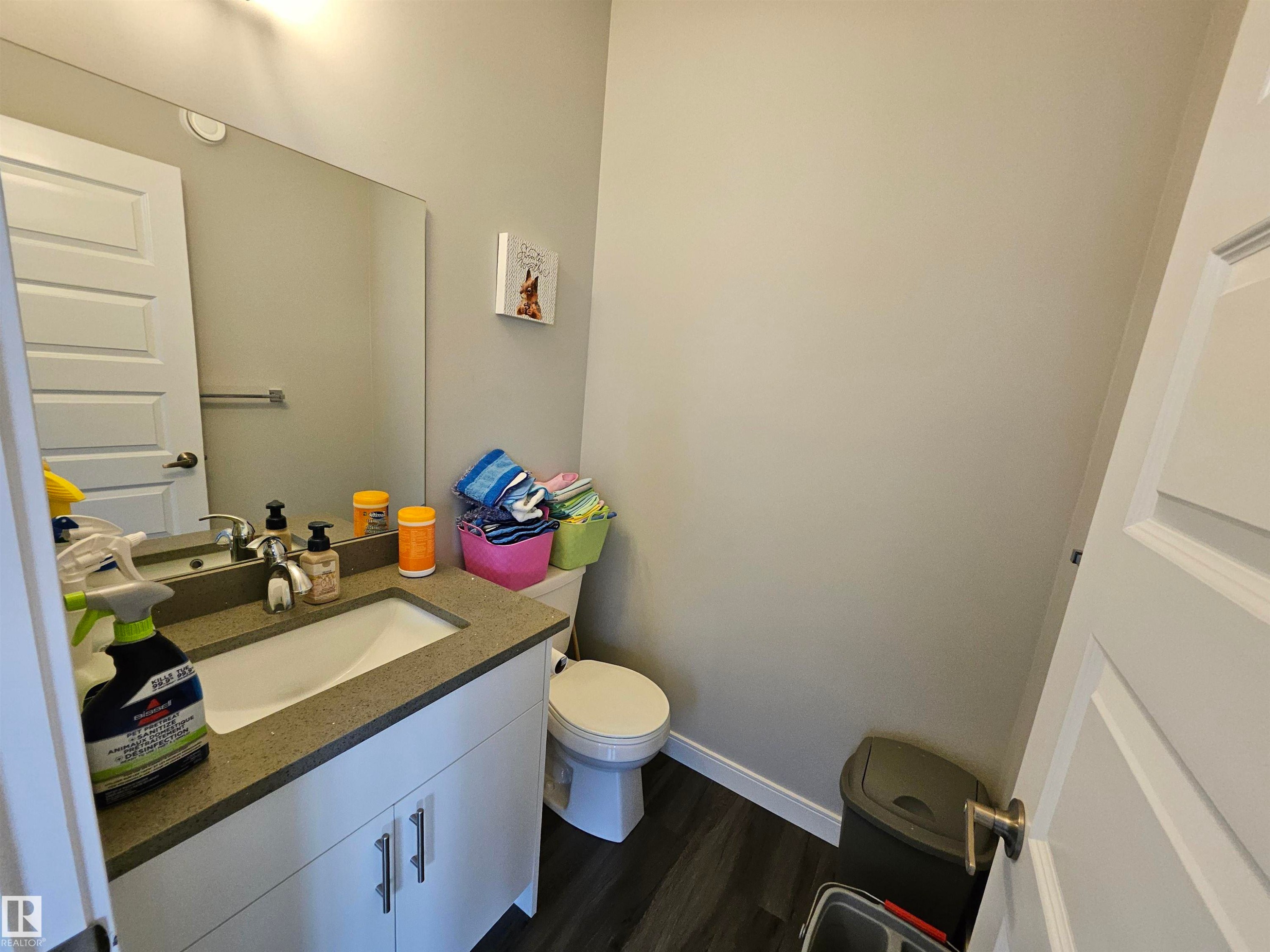 Vanity with integrated sink, quartz-finish countertop, and white cabinetry - 15212 98 Avenue Nw, Edmonton, AB - Indoor Photo Showing Bathroom