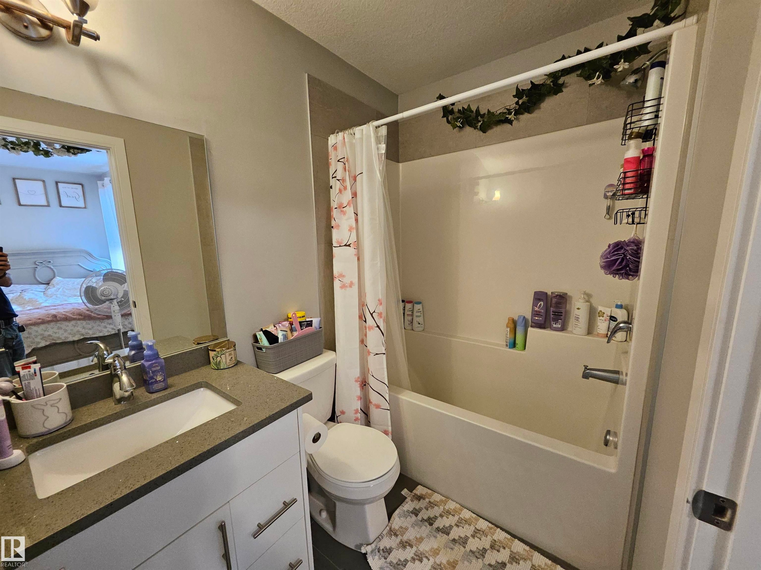 Bathroom featuring a white vanity with a grey countertop, an integrated sink, and a chrome faucet - 15212 98 Avenue Nw, Edmonton, AB - Indoor Photo Showing Bathroom