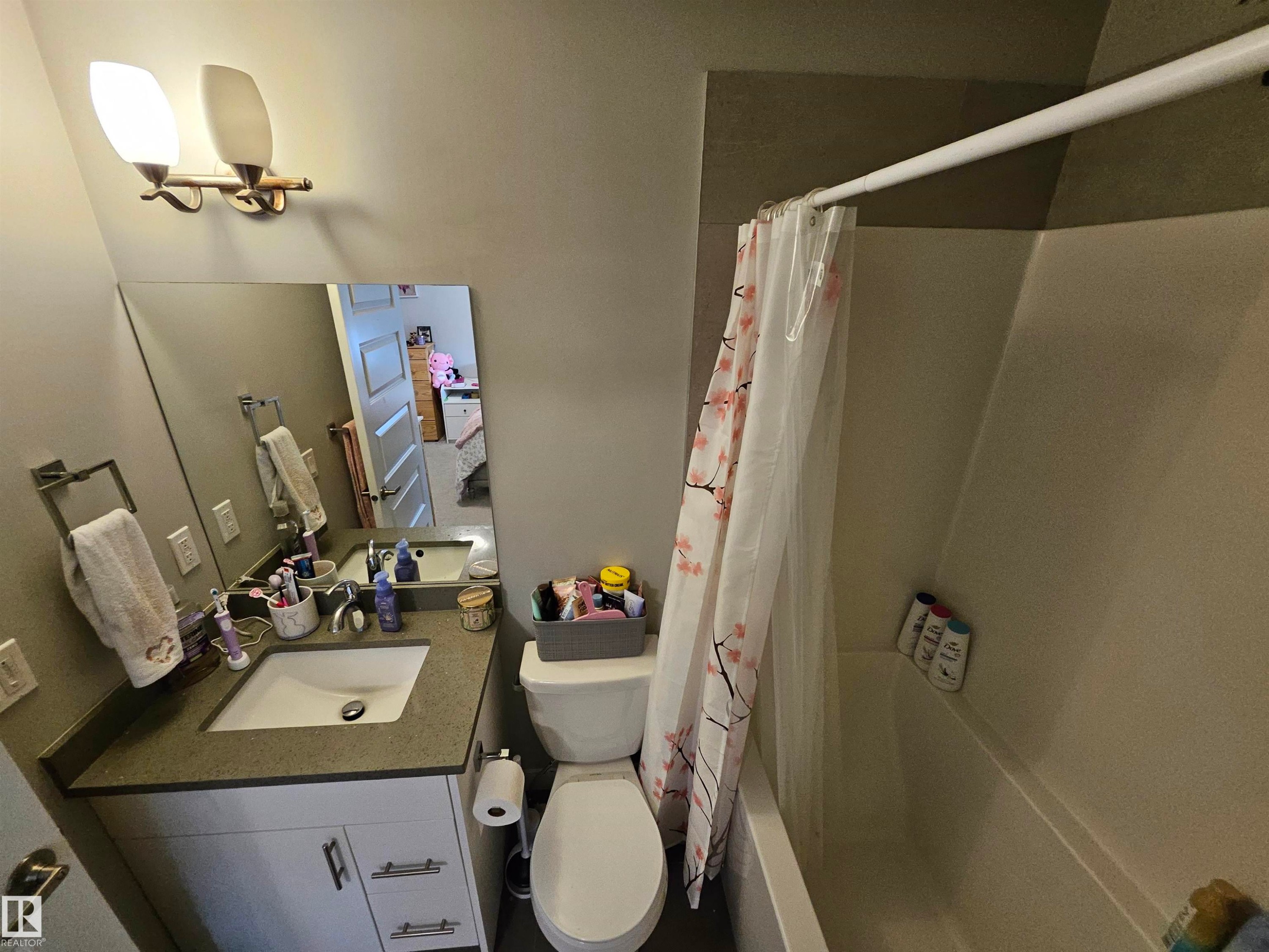 Vanity with integrated sink, stone-finish countertop, and white cabinetry - 15212 98 Avenue Nw, Edmonton, AB - Indoor Photo Showing Bathroom