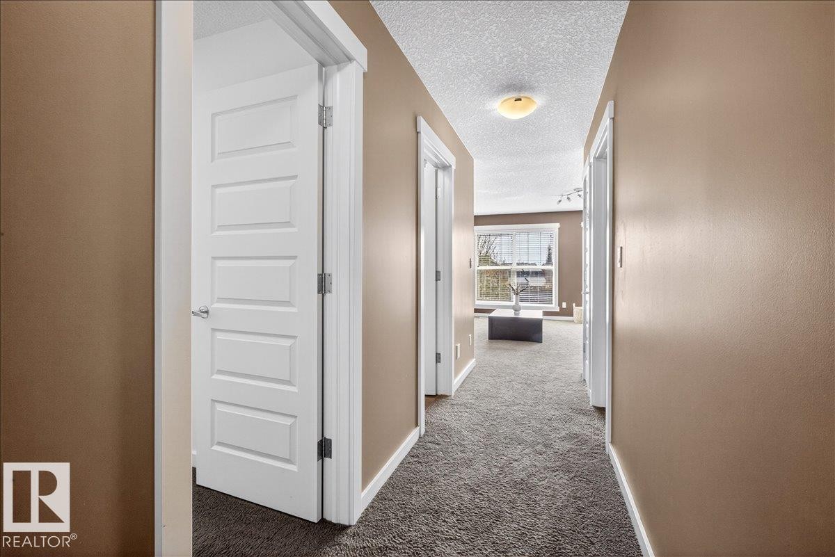 Hallway with textured carpeting and recessed lighting - 3936 Claxton Loop Sw, Edmonton, AB - Indoor Photo Showing Other Room