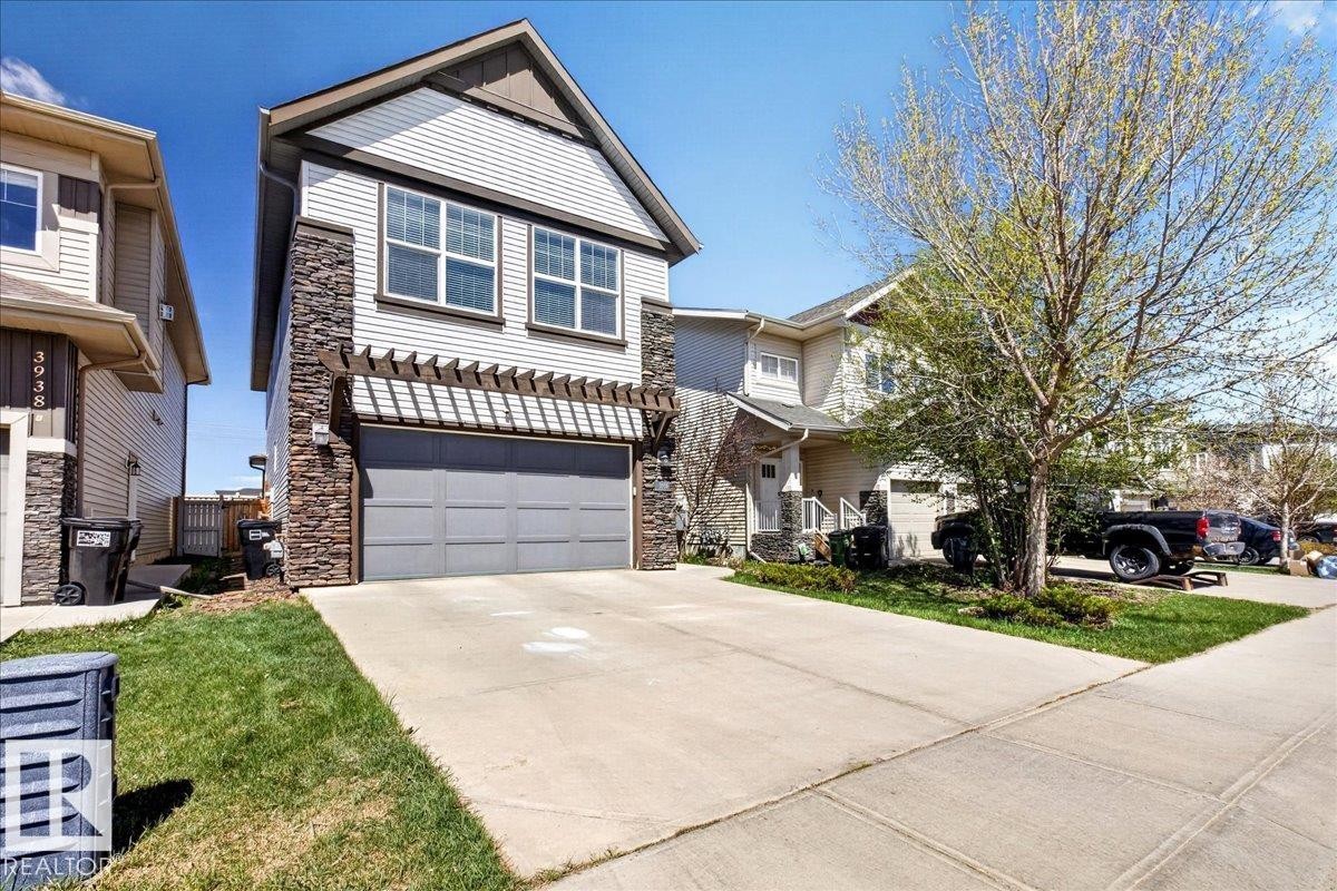 Contemporary exterior with siding and stone accents - 3936 Claxton Loop Sw, Edmonton, AB - Outdoor With Facade