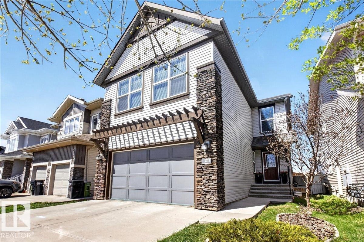 Modern two-story home featuring a striking mixed-material exterior combining stone accents and fiber cement siding - 3936 Claxton Loop Sw, Edmonton, AB - Outdoor With Facade