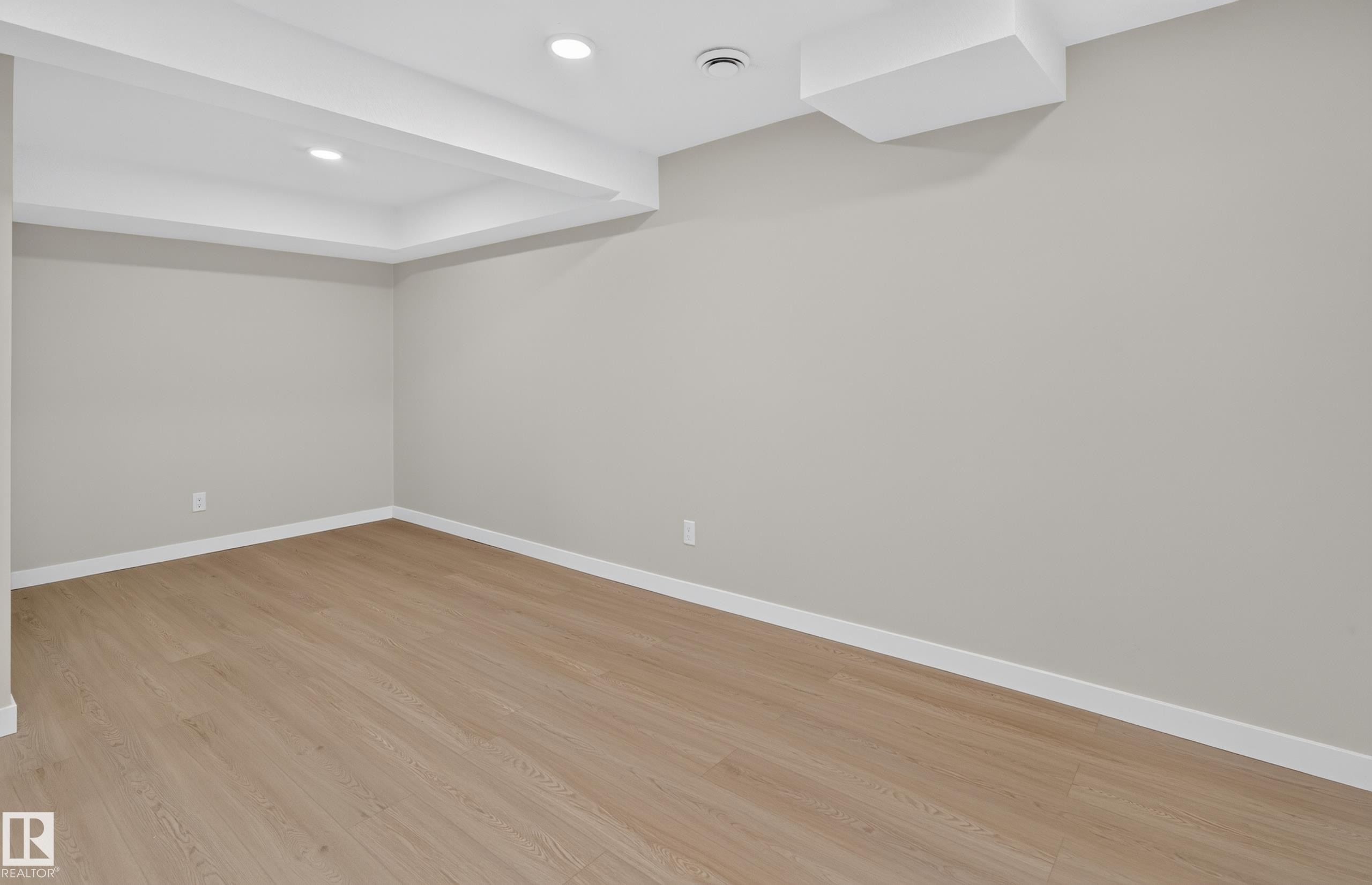 Recessed lighting, wood-finish flooring, light gray walls, and white trim - 175 Centennial Crest Nw, Edmonton, AB - Indoor Photo Showing Other Room