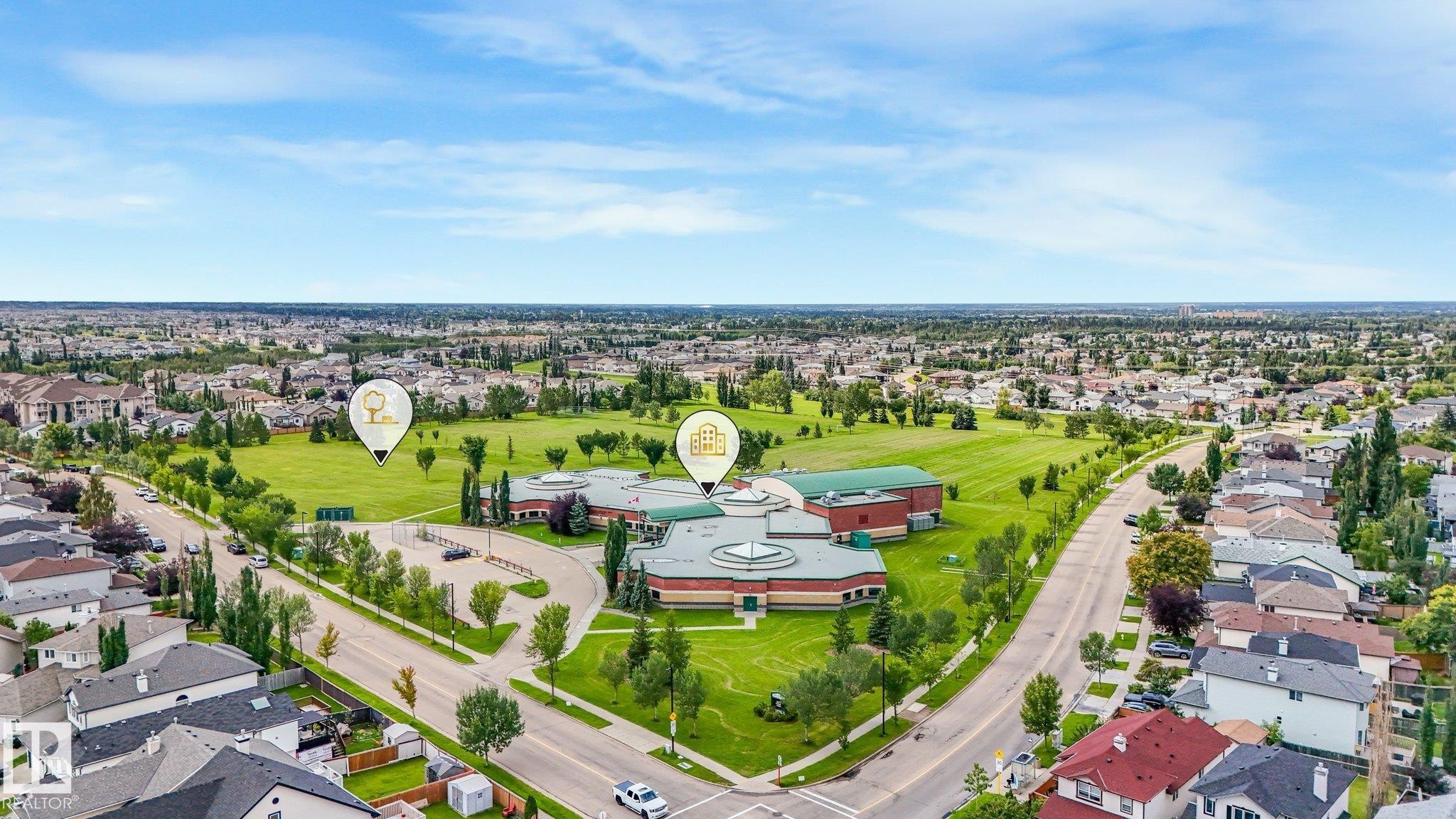 Expansive neighborhood featuring mature trees, residential properties, and a dedicated park area - 1478 37B Avenue Nw, Edmonton, AB - Outdoor With View