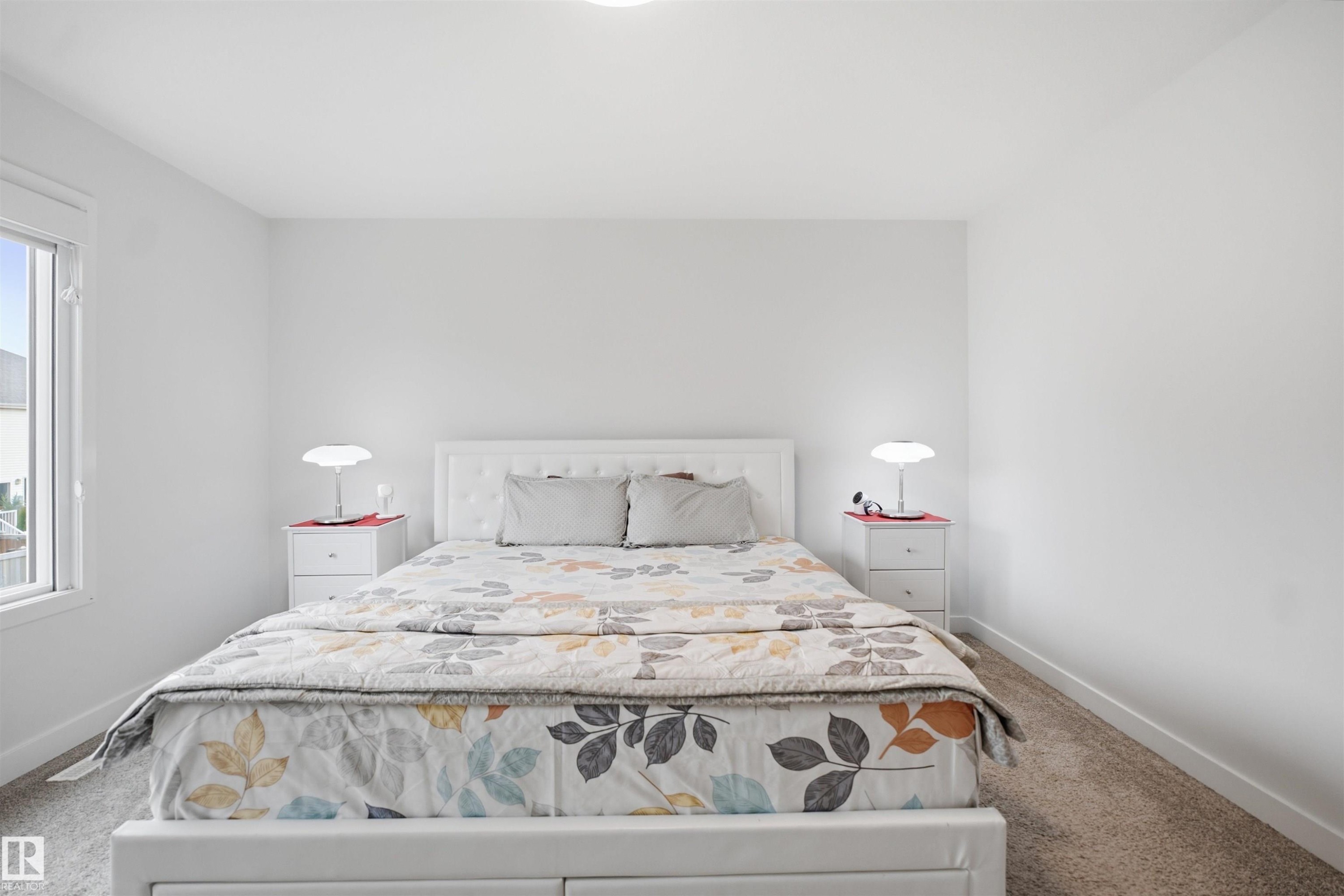 Bright room with light-toned carpeting and a window offering natural illumination - 3877 Chrustawka Place Sw, Edmonton, AB - Indoor Photo Showing Bedroom