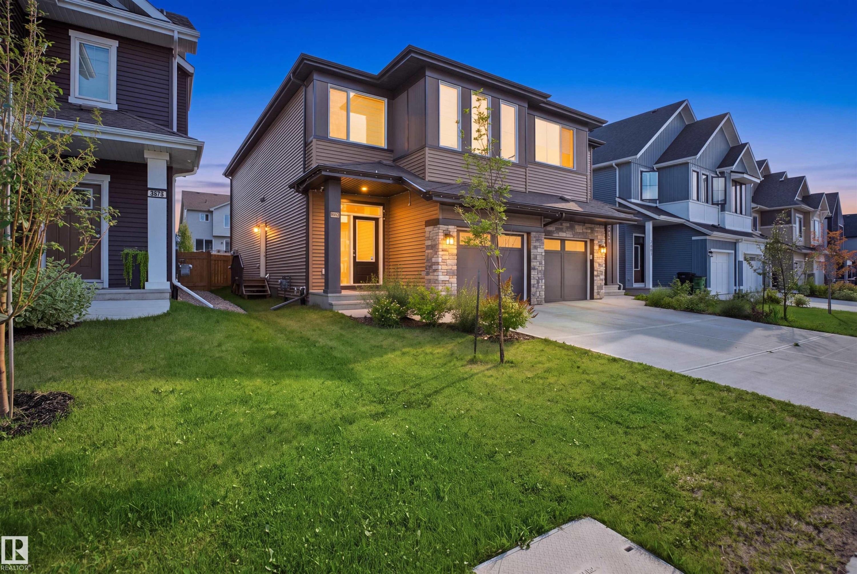 Modern exterior with horizontal siding and stone accents - 3877 Chrustawka Place Sw, Edmonton, AB - Outdoor With Facade