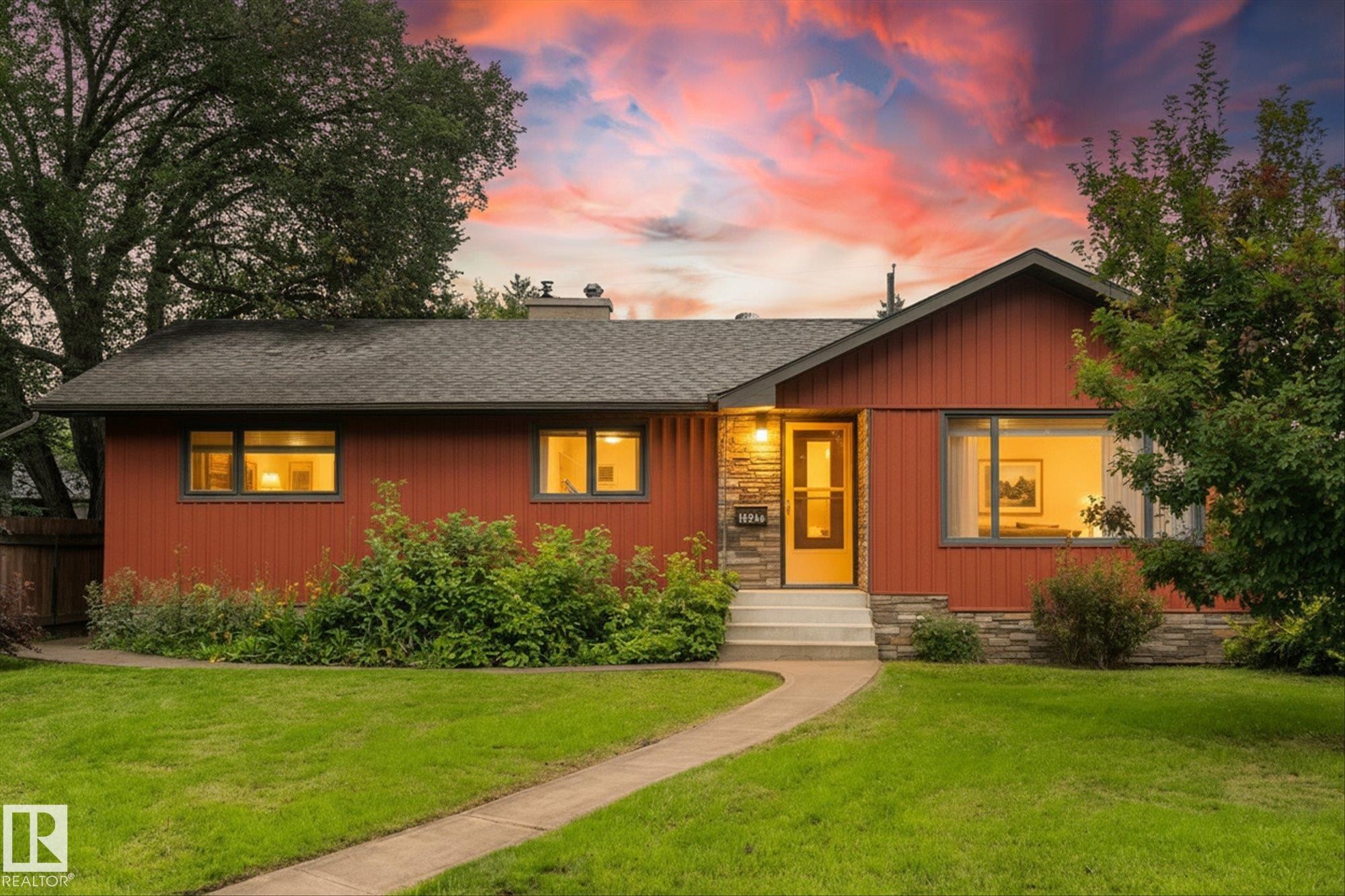 Charming brick ranch residence featuring a warm terracotta exterior with multiple windows flooding interior spaces with natural light - 15930 93 Avenue Nw, Edmonton, AB - Outdoor