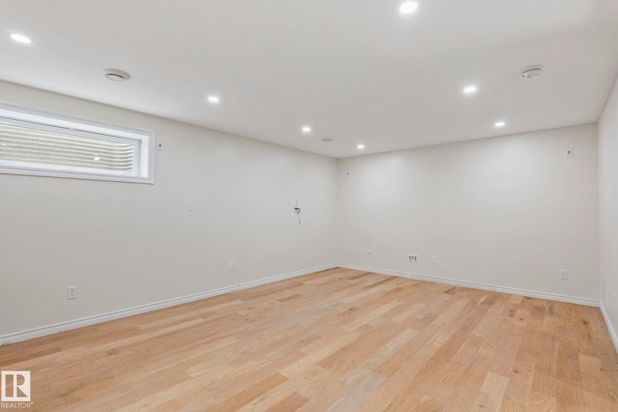Recessed ceiling lighting, wood-finish flooring, and a white-framed window - #80 4350 23St Nw, Edmonton, AB - Indoor