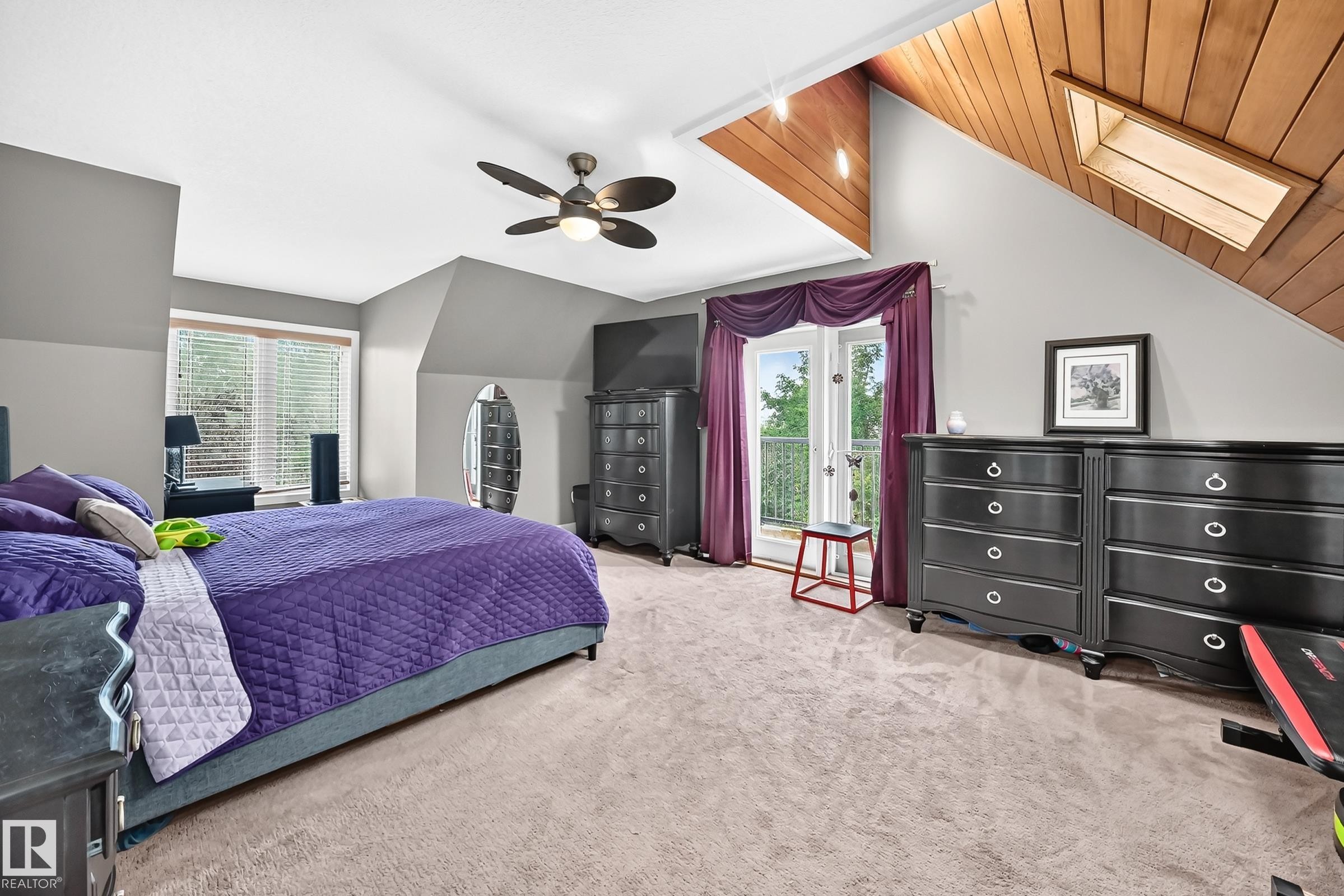 Sloped ceiling featuring wood-finish paneling and an integrated skylight - #38 24512 Sturgeon Rd, Rural Sturgeon County, AB