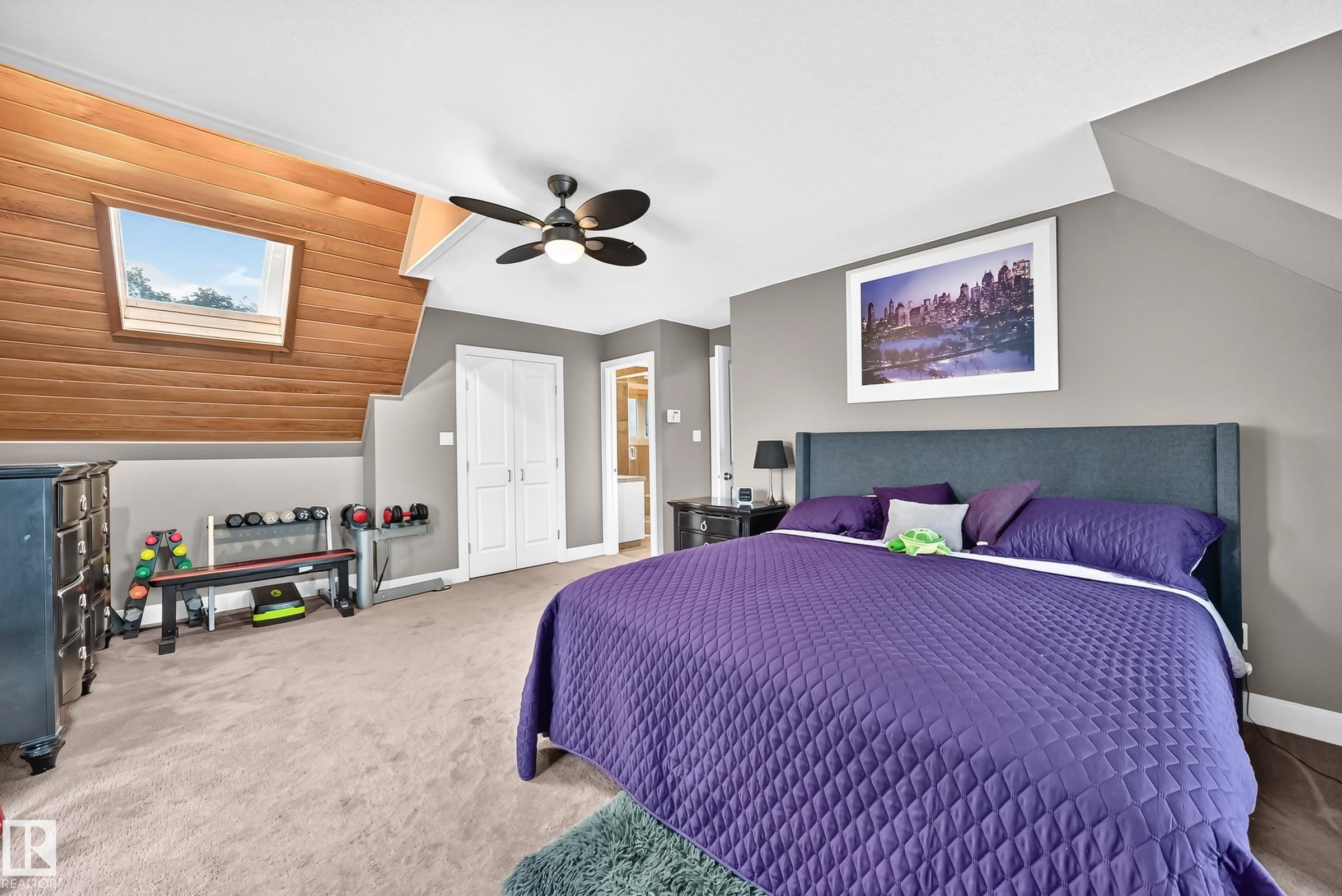 Sloped ceiling with wood-finish paneling and skylight - #38 24512 Sturgeon Rd, Rural Sturgeon County, AB
