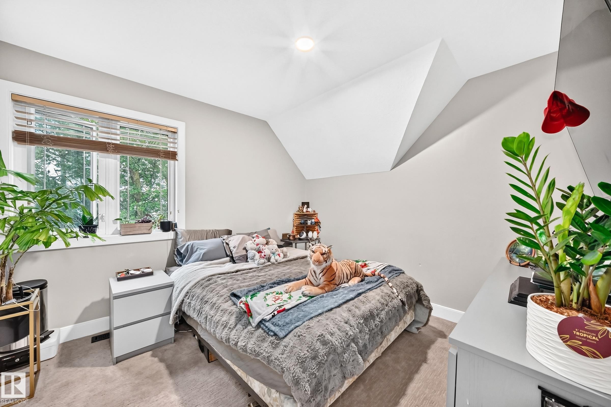Recessed ceiling lighting, light gray wall paint, window with blinds, sloped ceiling feature, and carpet flooring - #38 24512 Sturgeon Rd, Rural Sturgeon County, AB