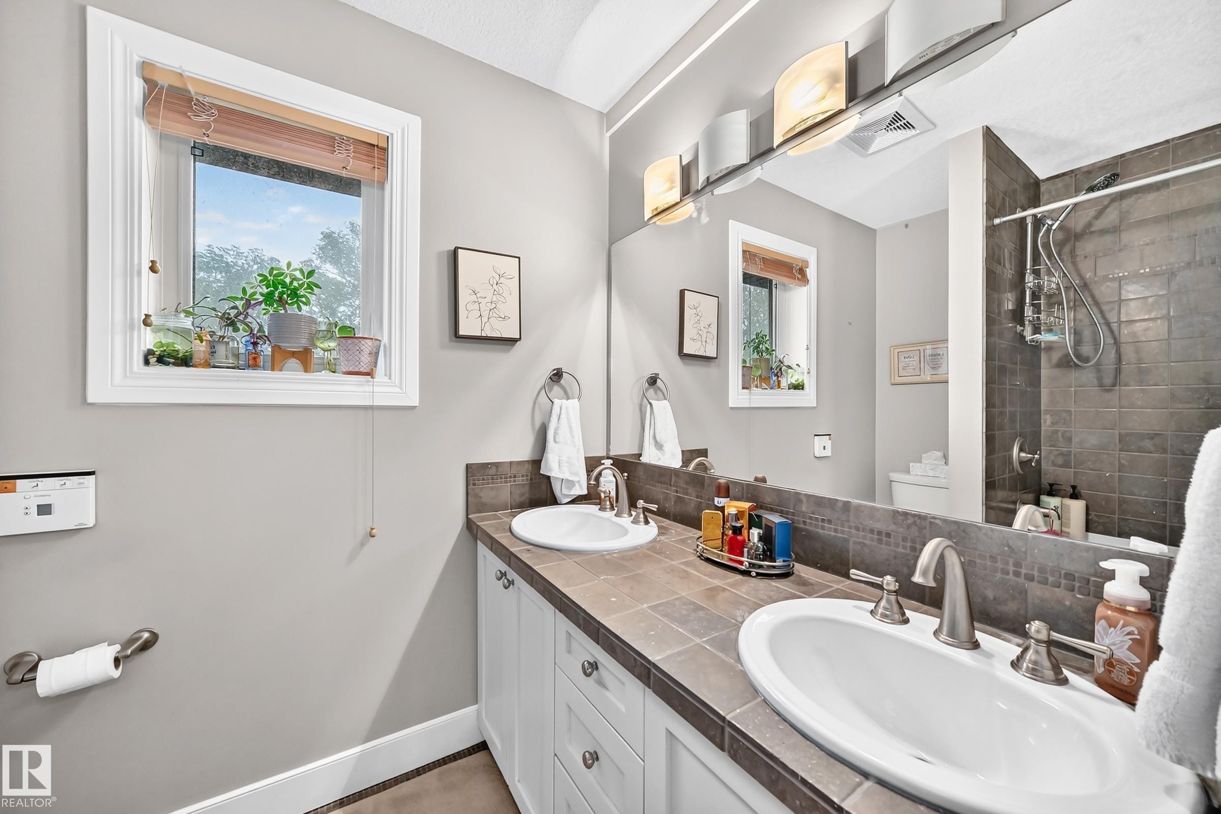 Dual basin vanity with tile countertop and integrated backsplash - #38 24512 Sturgeon Rd, Rural Sturgeon County, AB