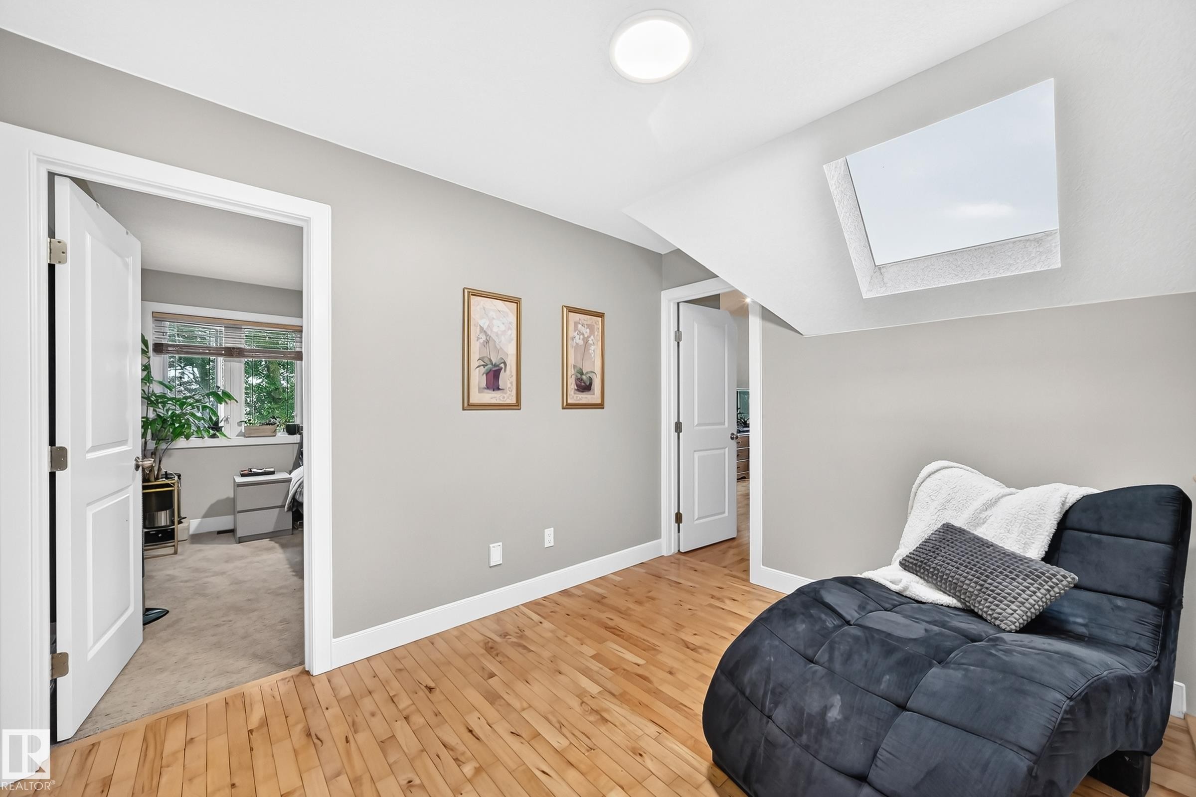 Hardwood flooring, light gray wall finishes, white trim, and a ceiling-mounted light fixture - #38 24512 Sturgeon Rd, Rural Sturgeon County, AB