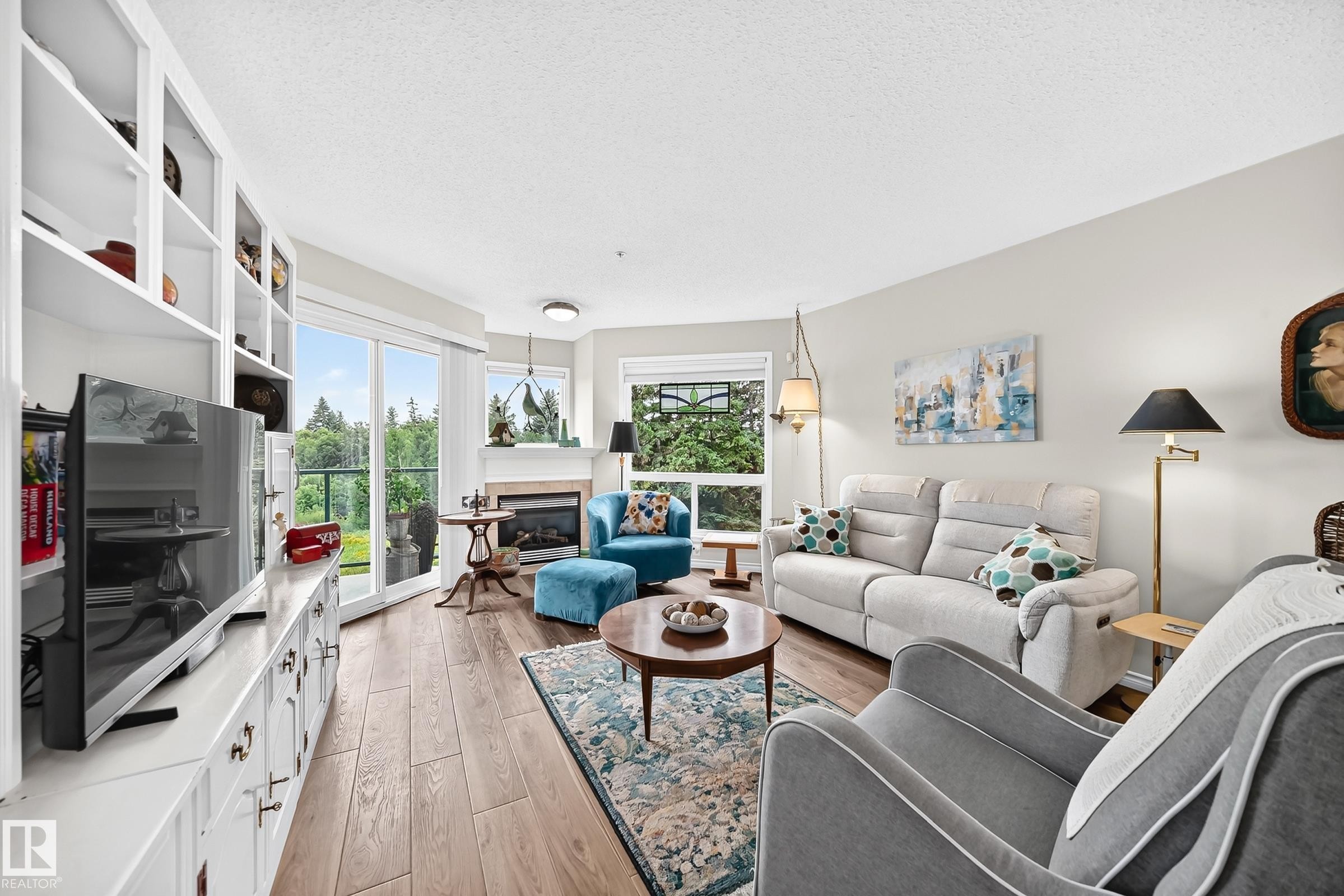 #209 102 Bridgeport Cx, Leduc, AB - Indoor Photo Showing Living Room With Fireplace