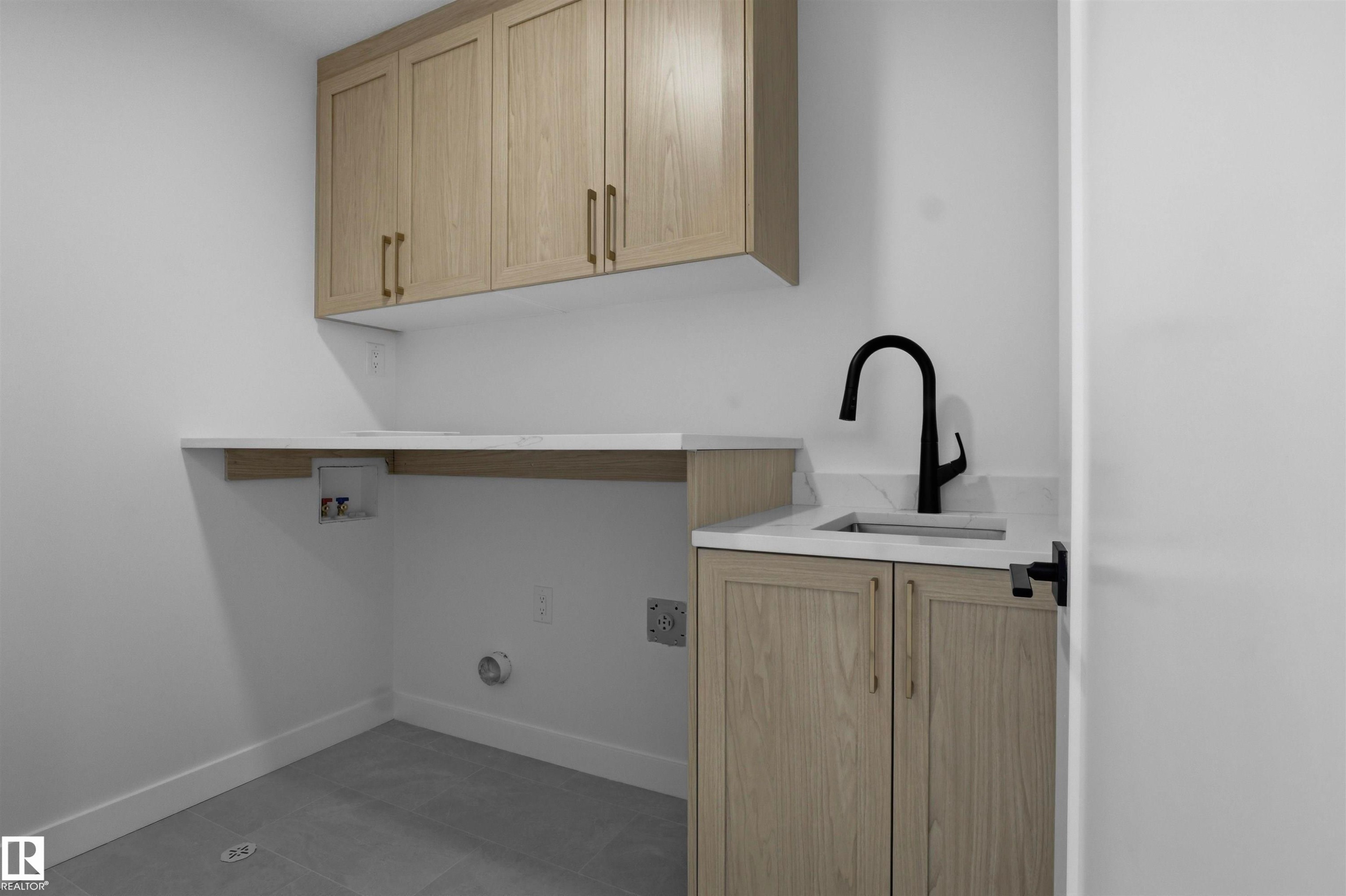 Upper wood-finish cabinetry with gold-tone hardware - 3304 Chickadee Drive Nw, Edmonton, AB - Indoor
