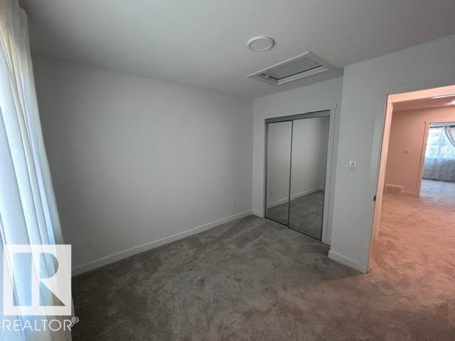 Plush carpeting, mirrored closet doors, and recessed ceiling lighting - 20936 16 Avenue Nw, Edmonton, AB - Indoor Photo Showing Other Room