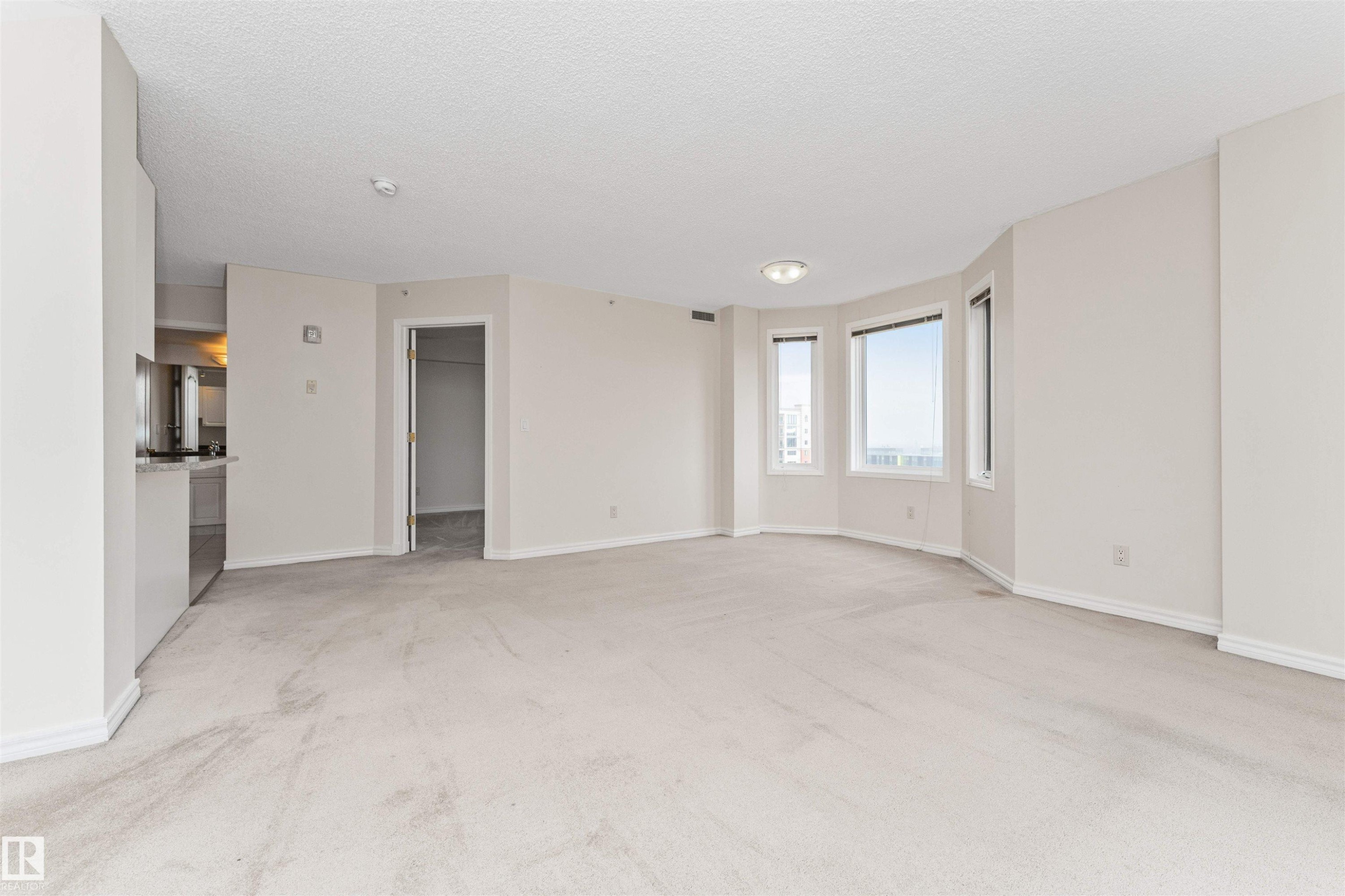 Open-concept living area with light-colored carpeting - #1101 10909 103 Av Nw, Edmonton, AB - Indoor Photo Showing Other Room