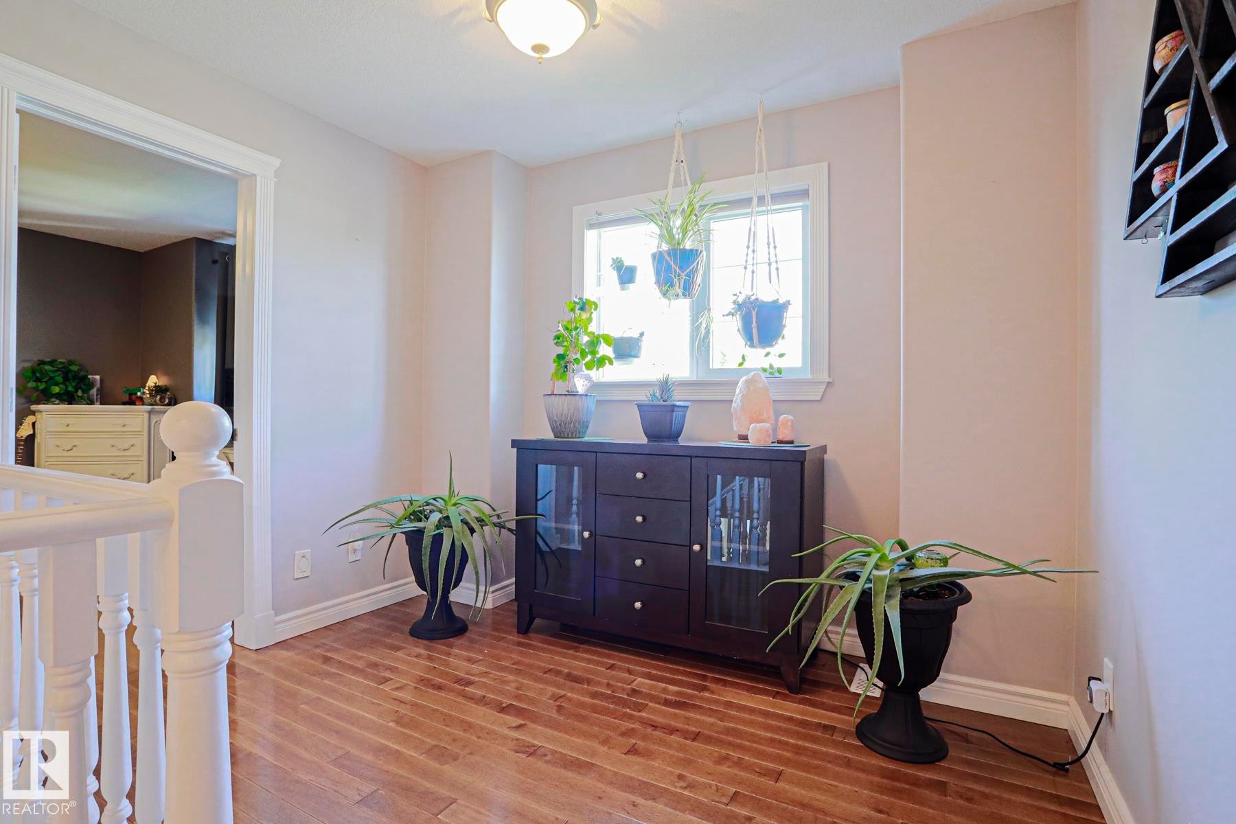 Hardwood-finish flooring, white trim, and a window with natural light - 12 Douziech Close, St. Albert, AB - Indoor