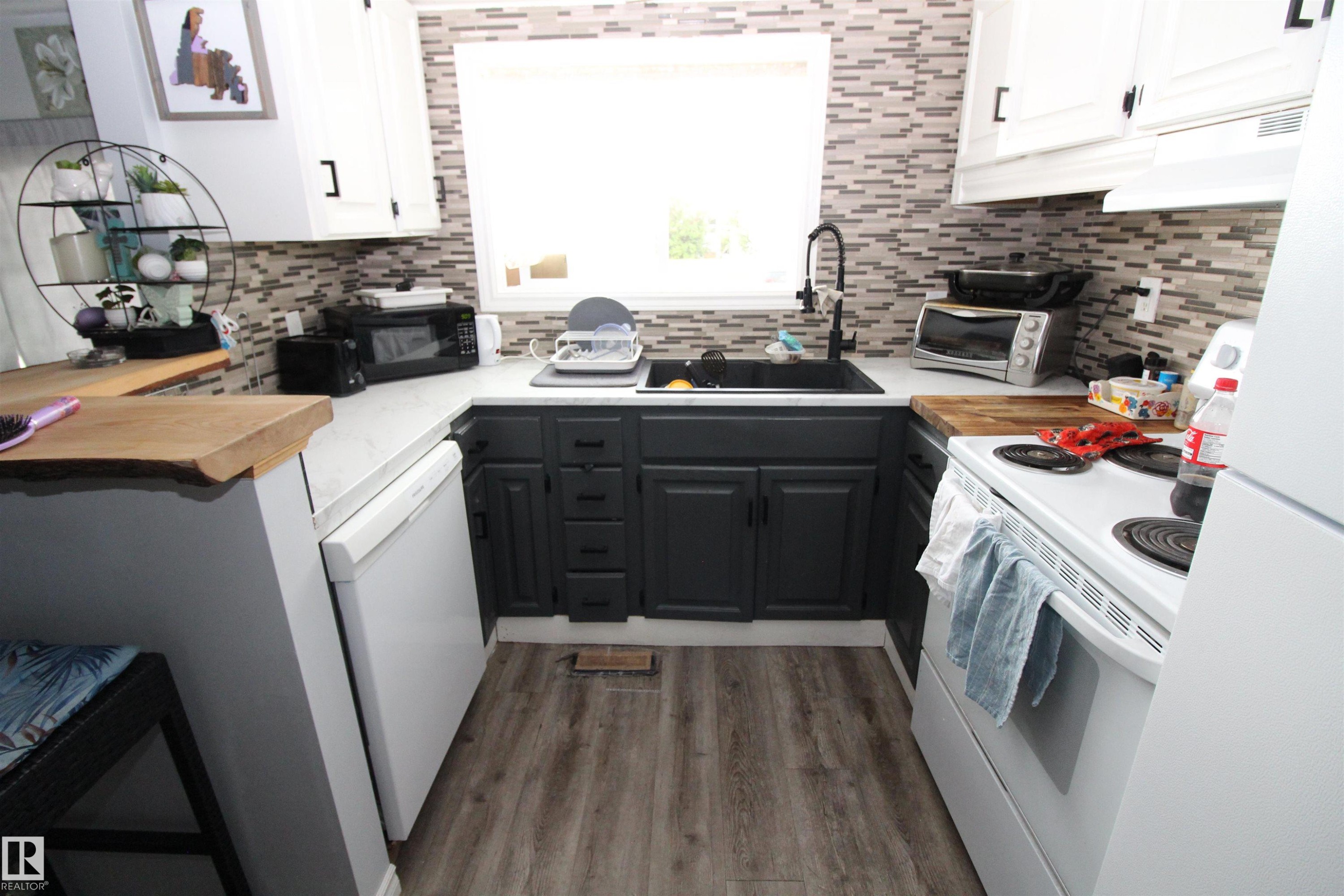 5404 52 Street, Clyde, AB - Indoor Photo Showing Kitchen With Fireplace