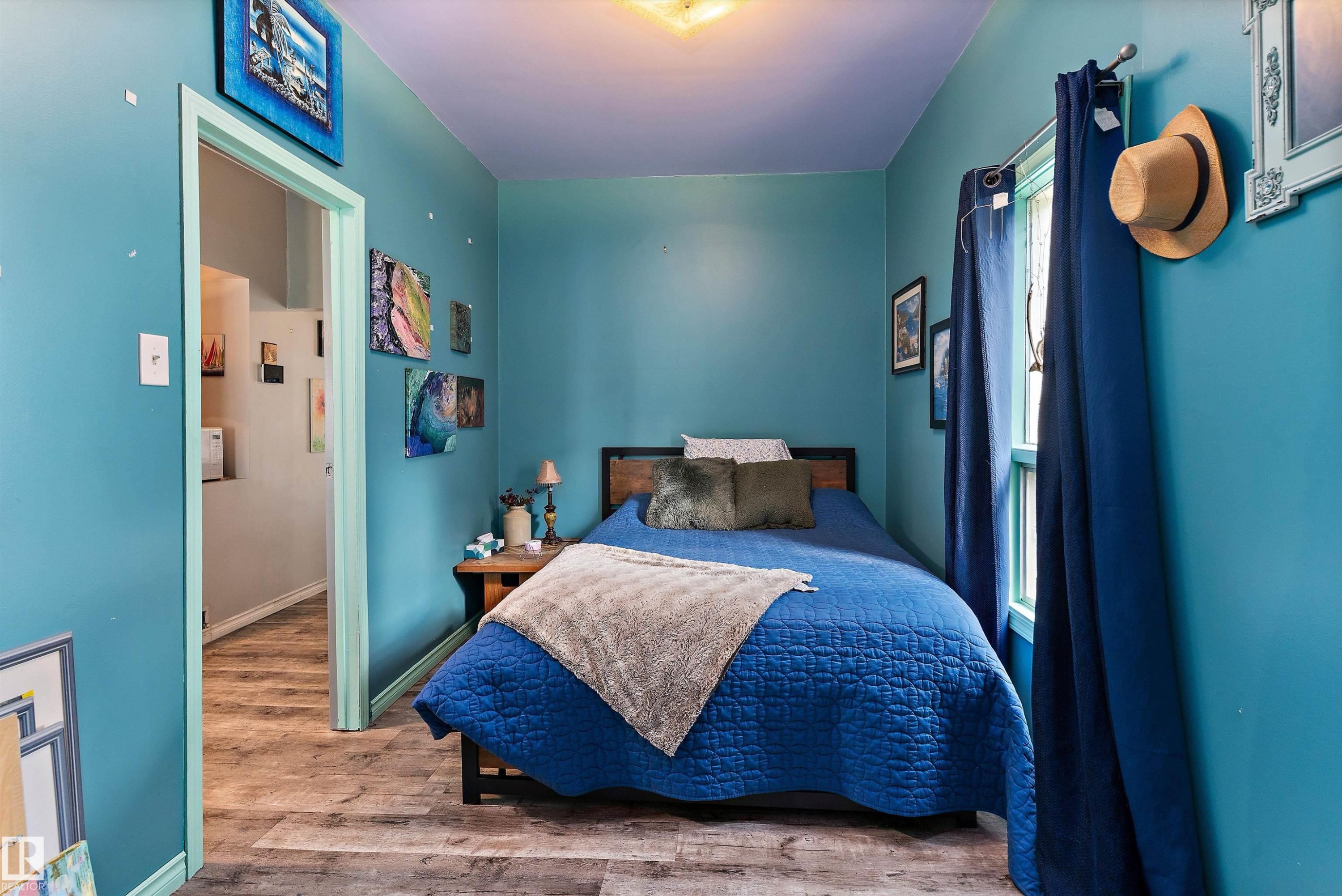 Luxury vinyl plank flooring throughout, featuring a window and a ceiling-mounted light fixture - 5404 45 Avenue, Wetaskiwin, AB - Indoor Photo Showing Bedroom