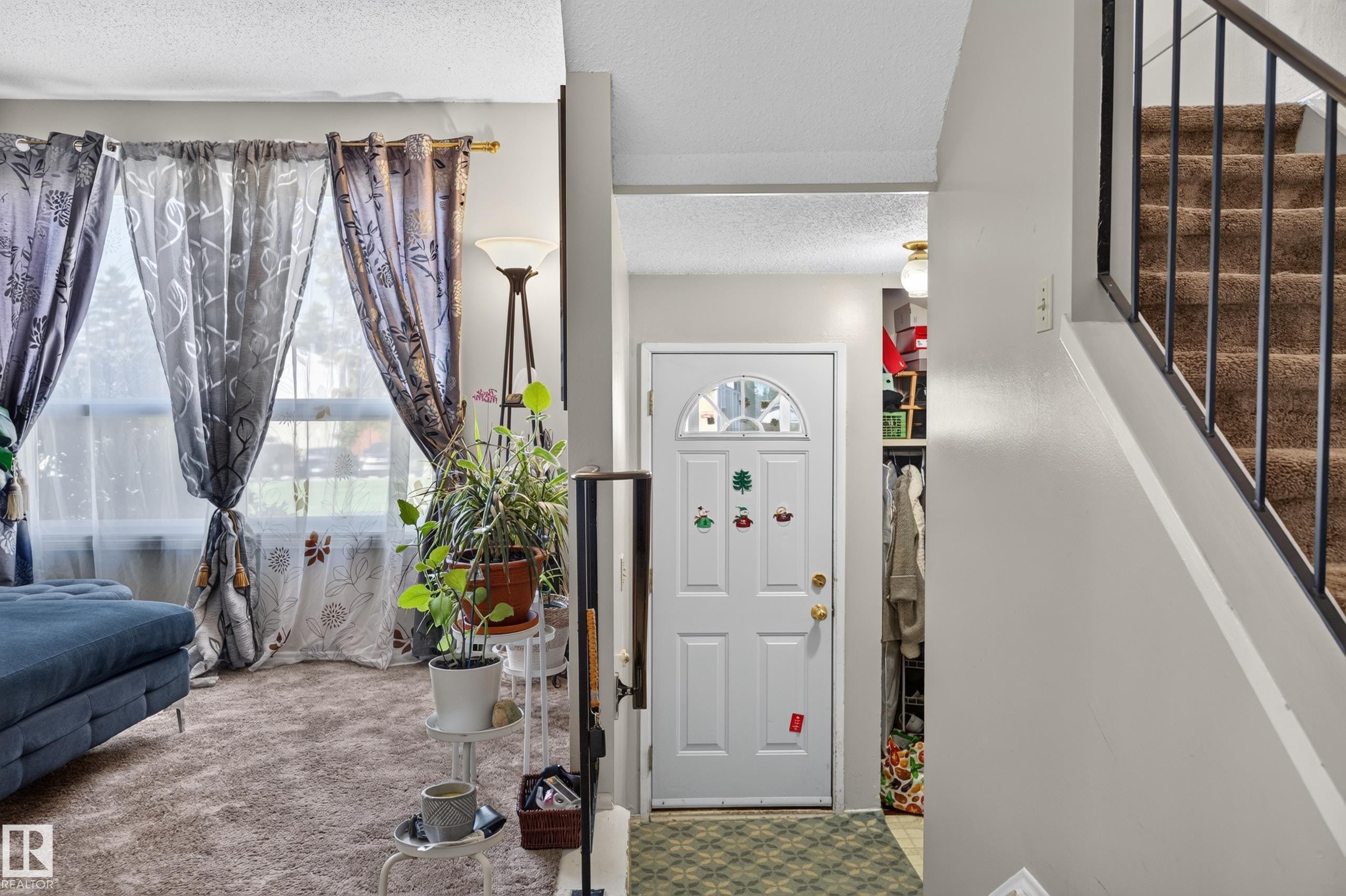 Entryway with a paneled door, arched glass insert, and adjacent open shelving - 18247 93 Avenue Nw, Edmonton, AB - Indoor Photo Showing Other Room