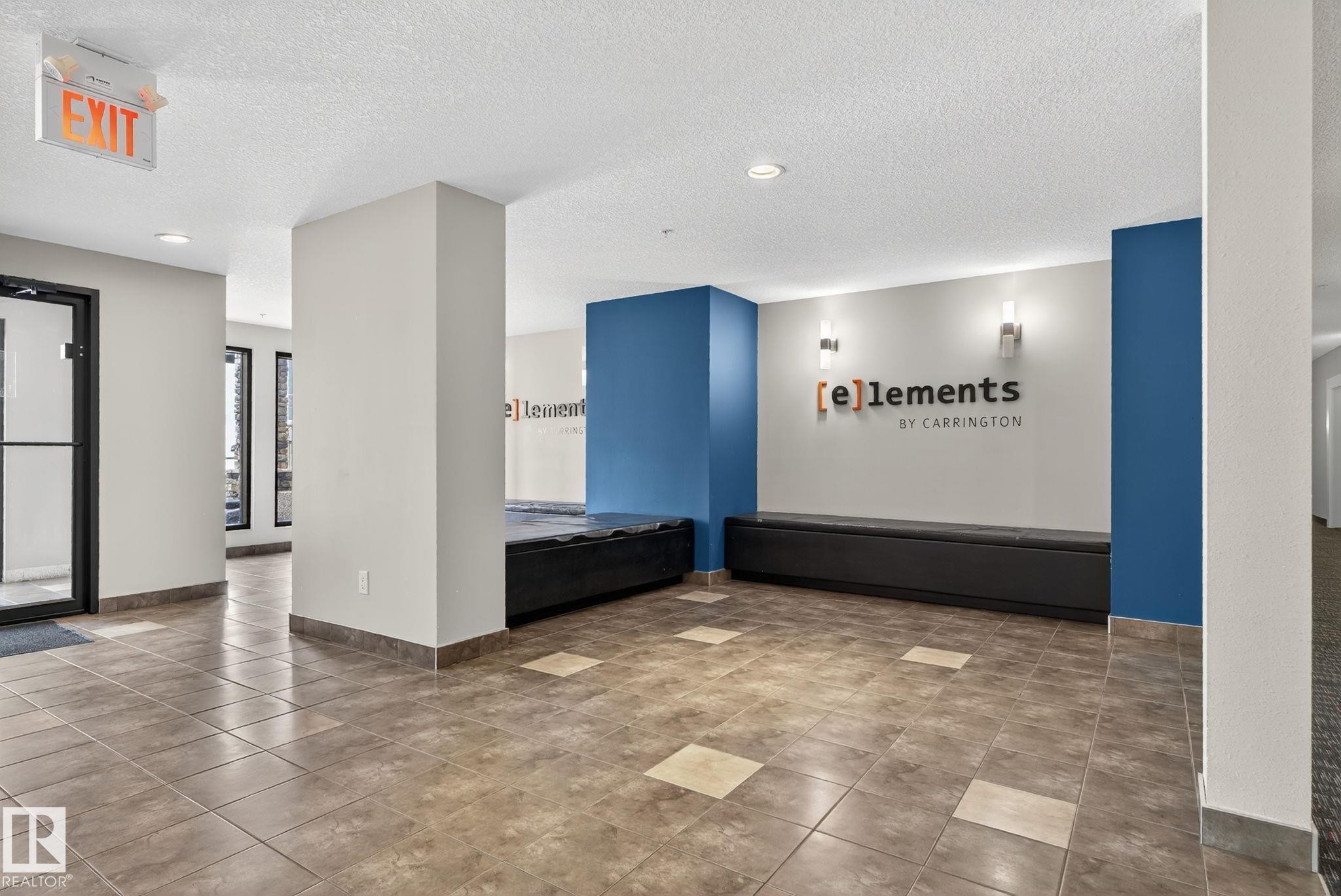Tiled flooring with contrasting accent squares, built-in black benches, contemporary wall sconces, and recessed lighting - 3353 16A Avenue Nw, Edmonton, AB - Indoor Photo Showing Other Room