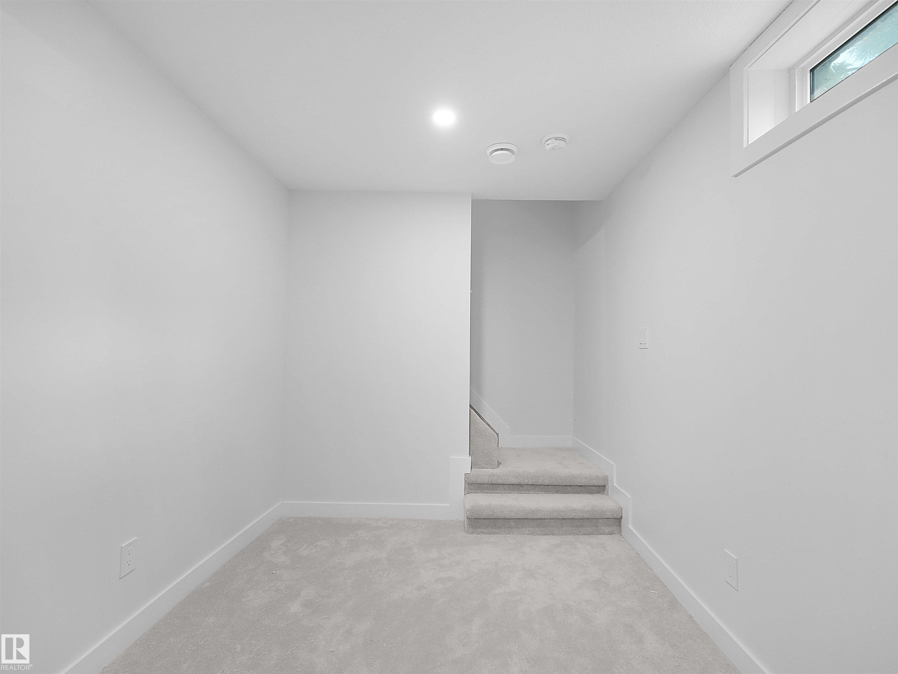 Recessed lighting, light gray carpeting, neutral wall color, and a window providing natural illumination - 126 Woodstock Nw, Edmonton, AB - Indoor Photo Showing Other Room