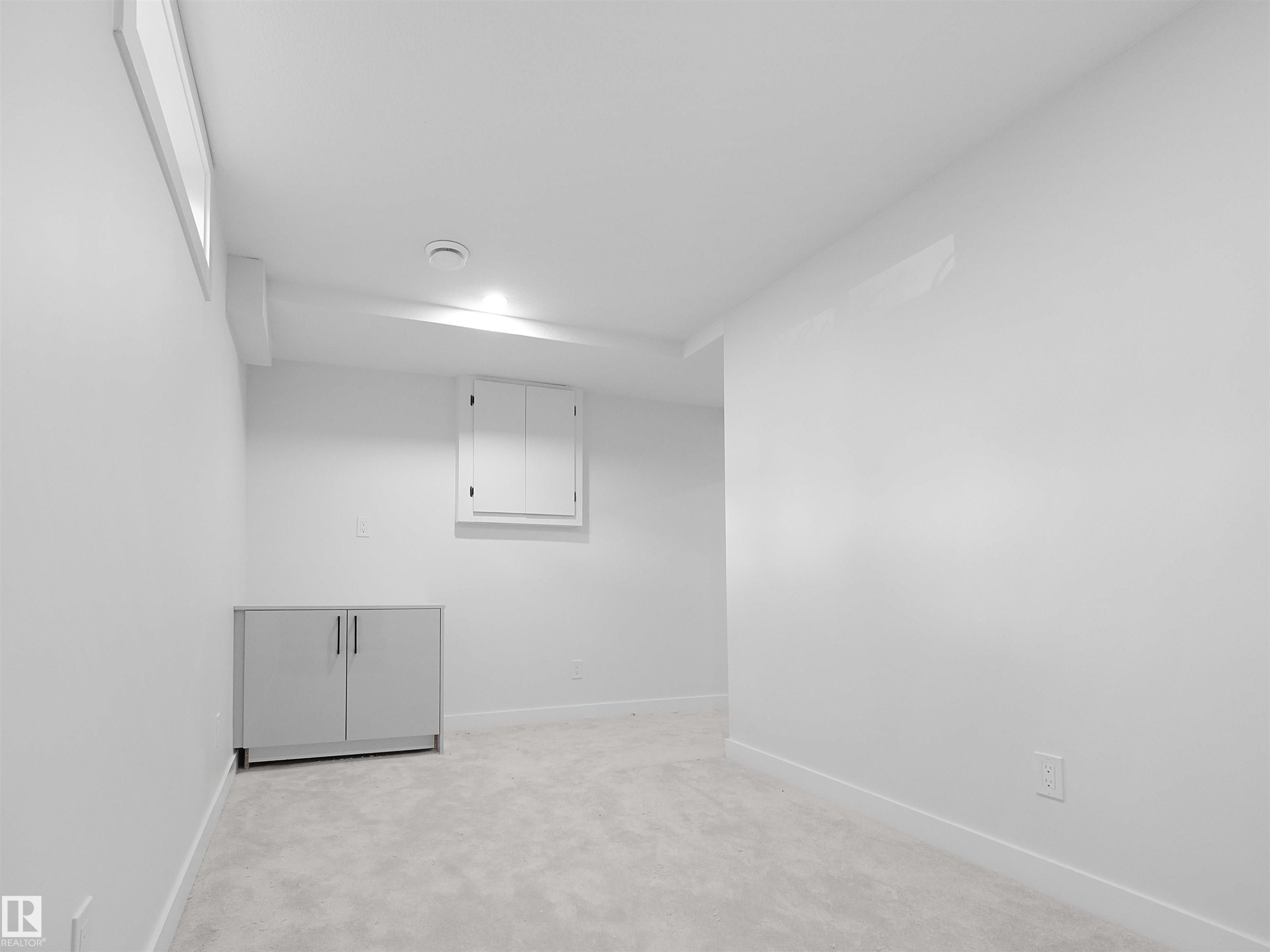Recessed lighting illuminates the space, featuring light gray carpeting and a built-in window - 126 Woodstock Nw, Edmonton, AB - Indoor Photo Showing Other Room