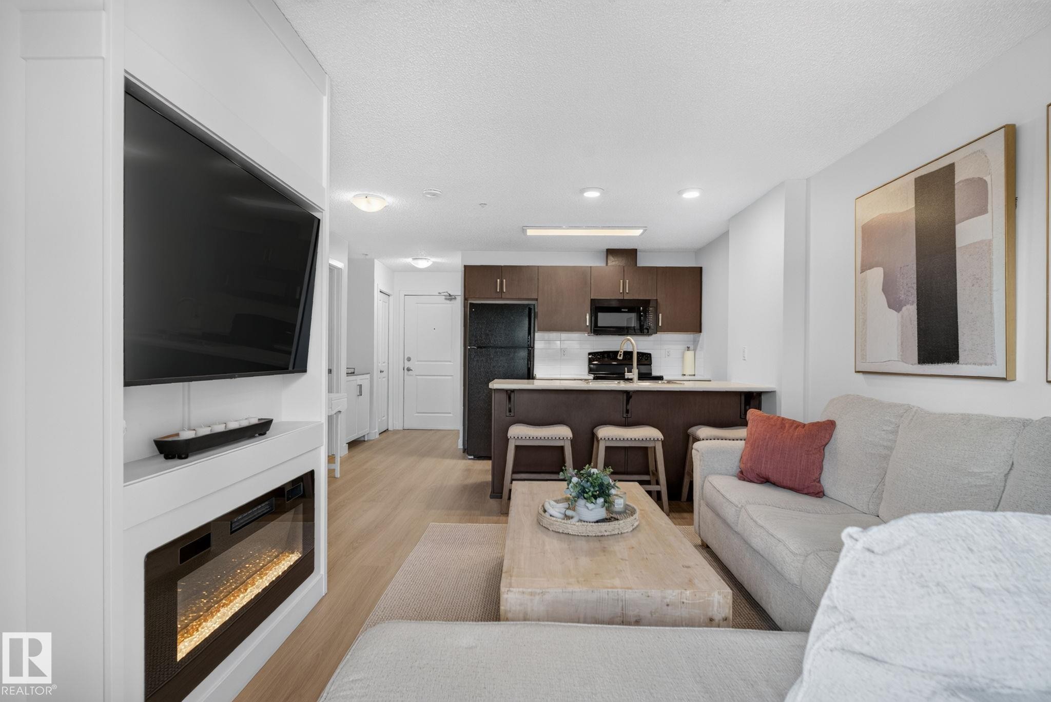 #203 5521 7 Av Sw, Edmonton, AB - Indoor Photo Showing Living Room With Fireplace