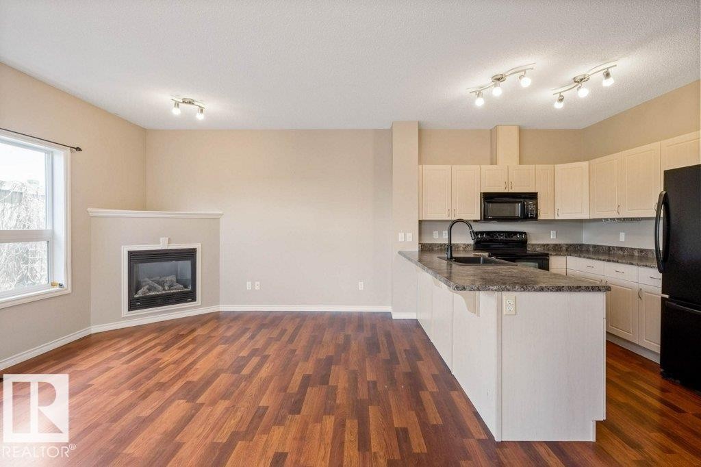 #59 3010 33 Av Nw, Edmonton, AB - Indoor Photo Showing Kitchen With Fireplace
