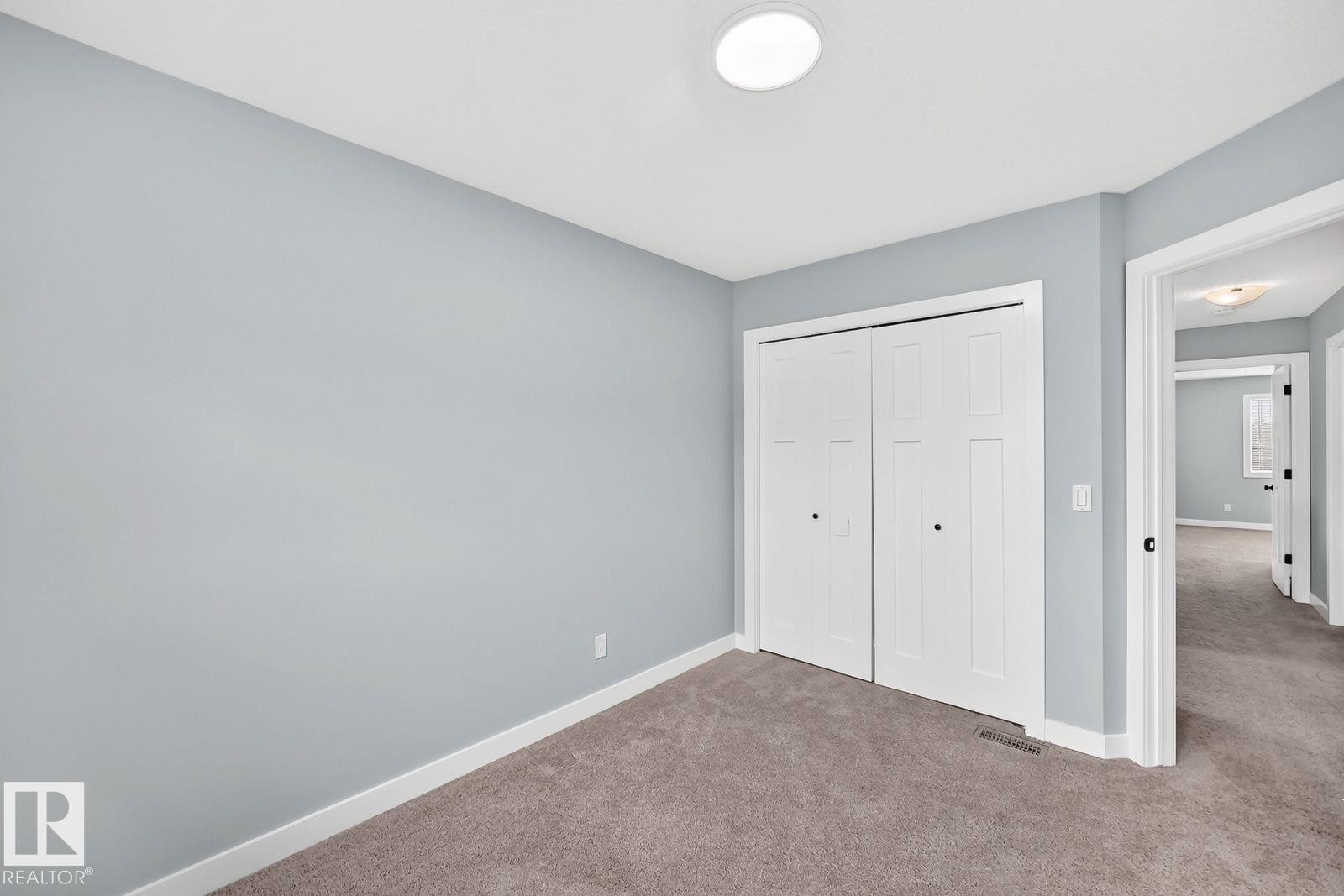 Recessed ceiling lighting, a bi-fold closet, and soft gray carpet flooring - 1112 176 Street Sw, Edmonton, AB - Indoor Photo Showing Other Room